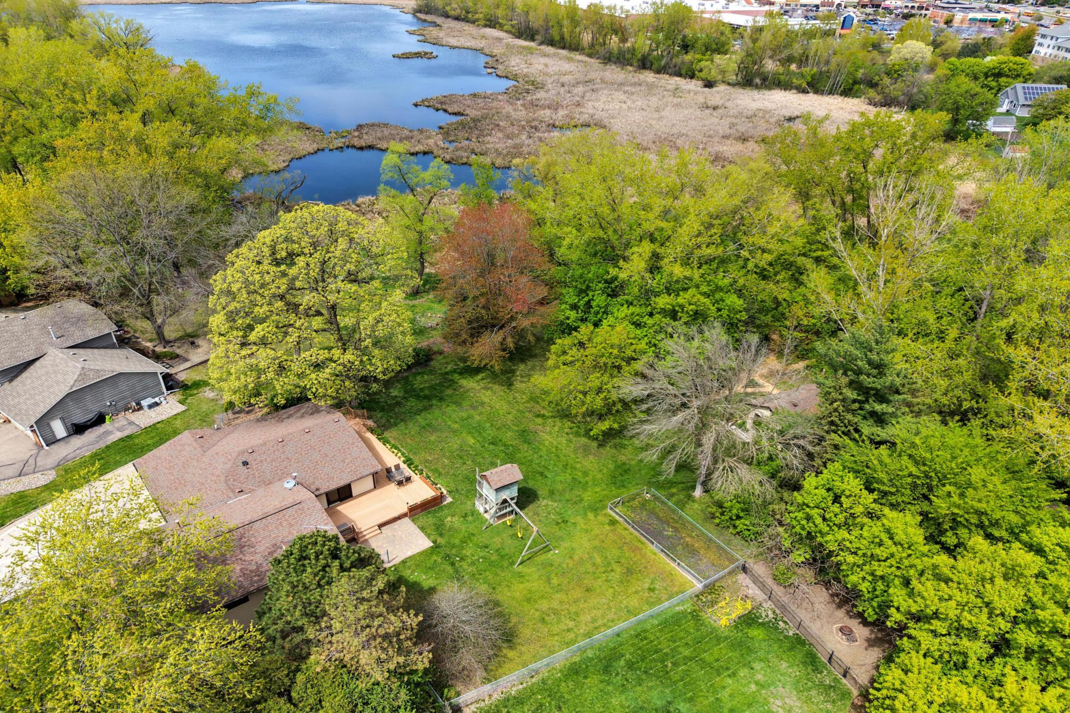 Gorgeous 1 acre lot with a backdrop of woods and water!