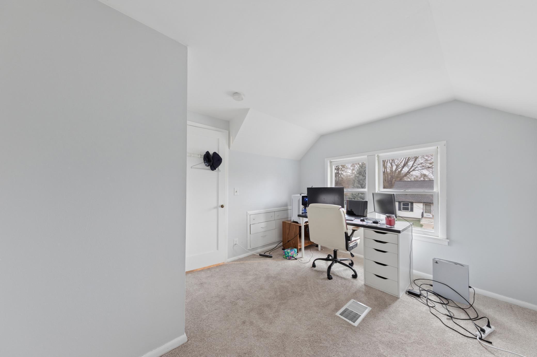 Versatile upper-level space perfect for a home office, bedroom, or flex area with natural light.