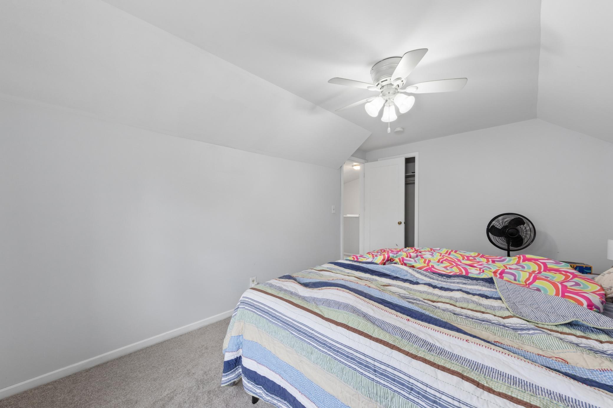 Large upper-level bedroom with ample space, closet access, and cozy finishes.