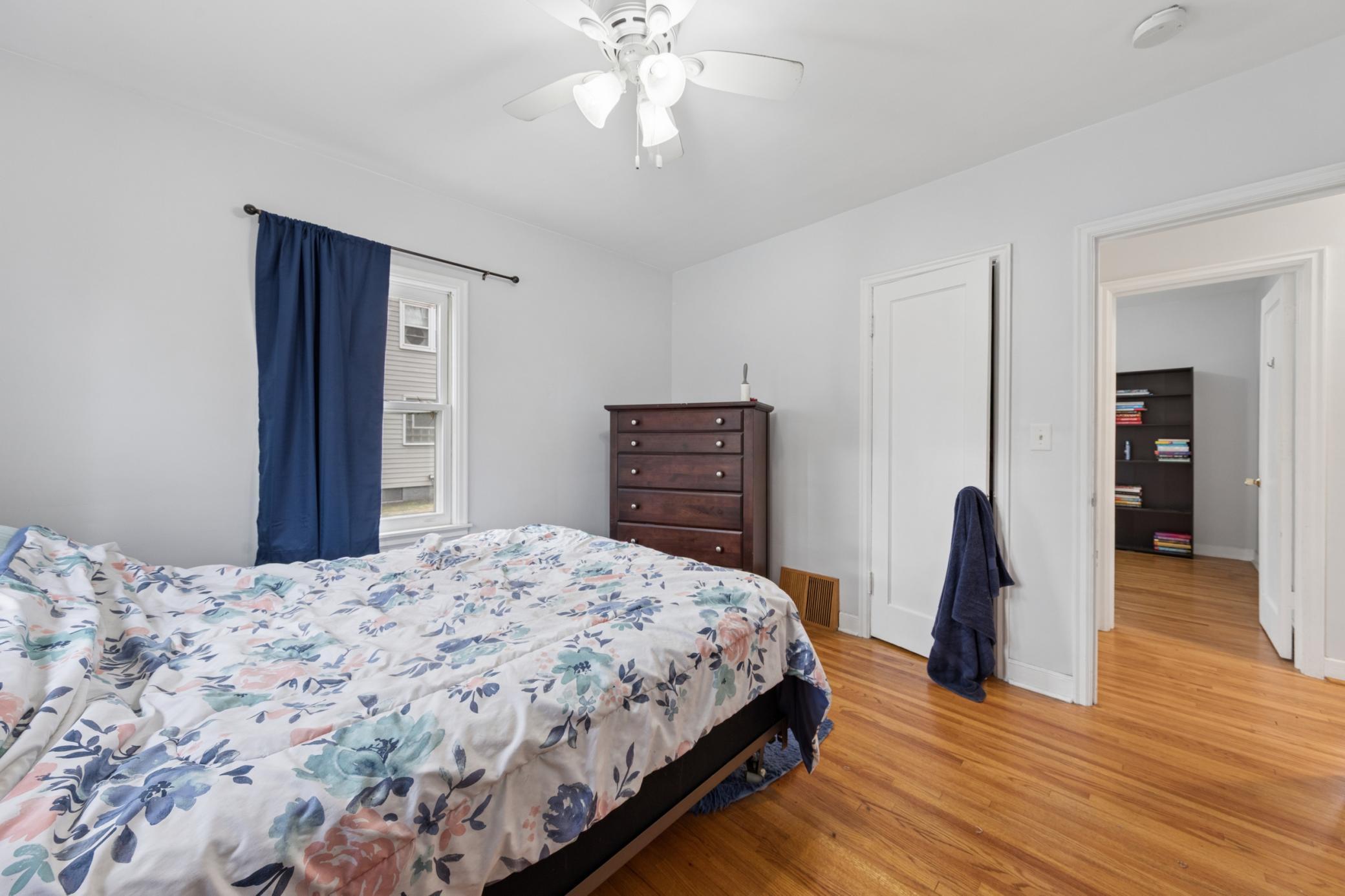 Bright bedroom with dual windows, neutral décor, and great layout flexibility.