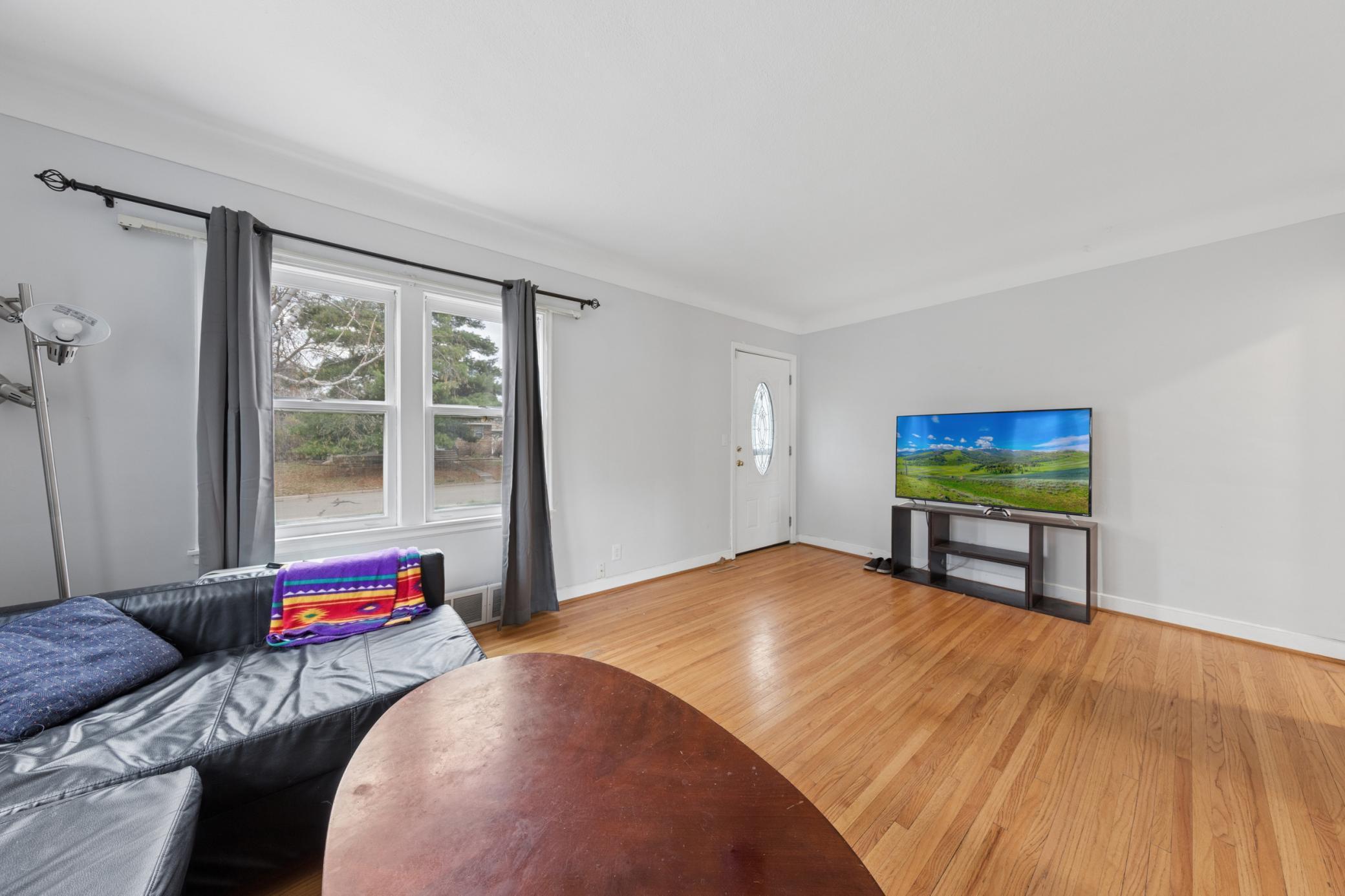 Light-filled living area featuring neutral tones, updated flooring, and flexible furniture layout.
