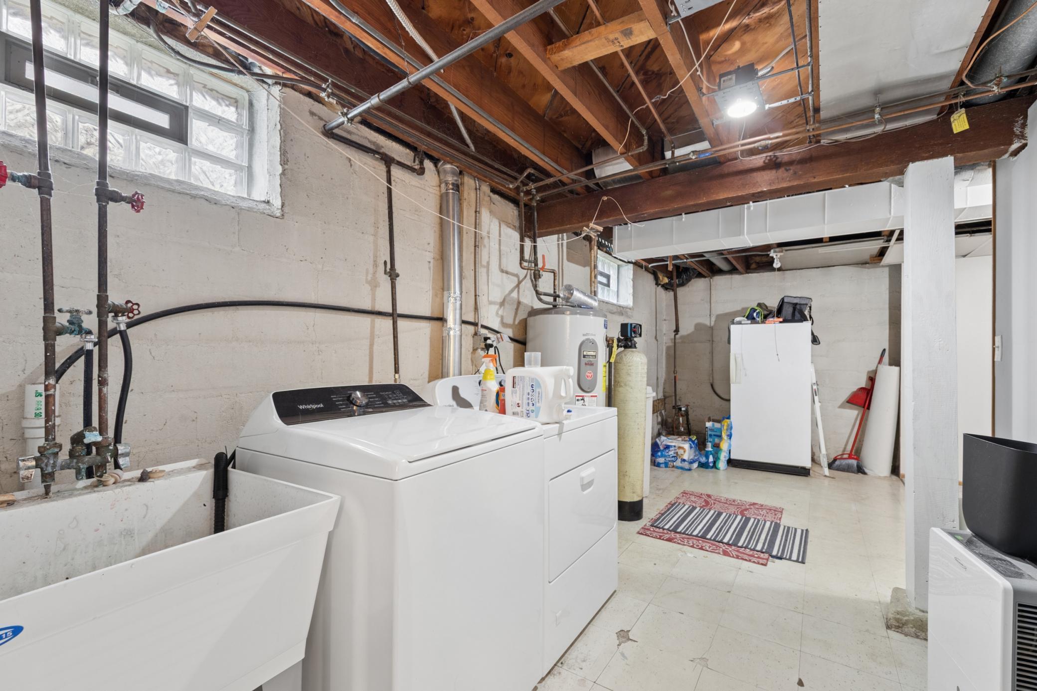 Spacious utility room featuring mechanicals, storage, and room for organization.