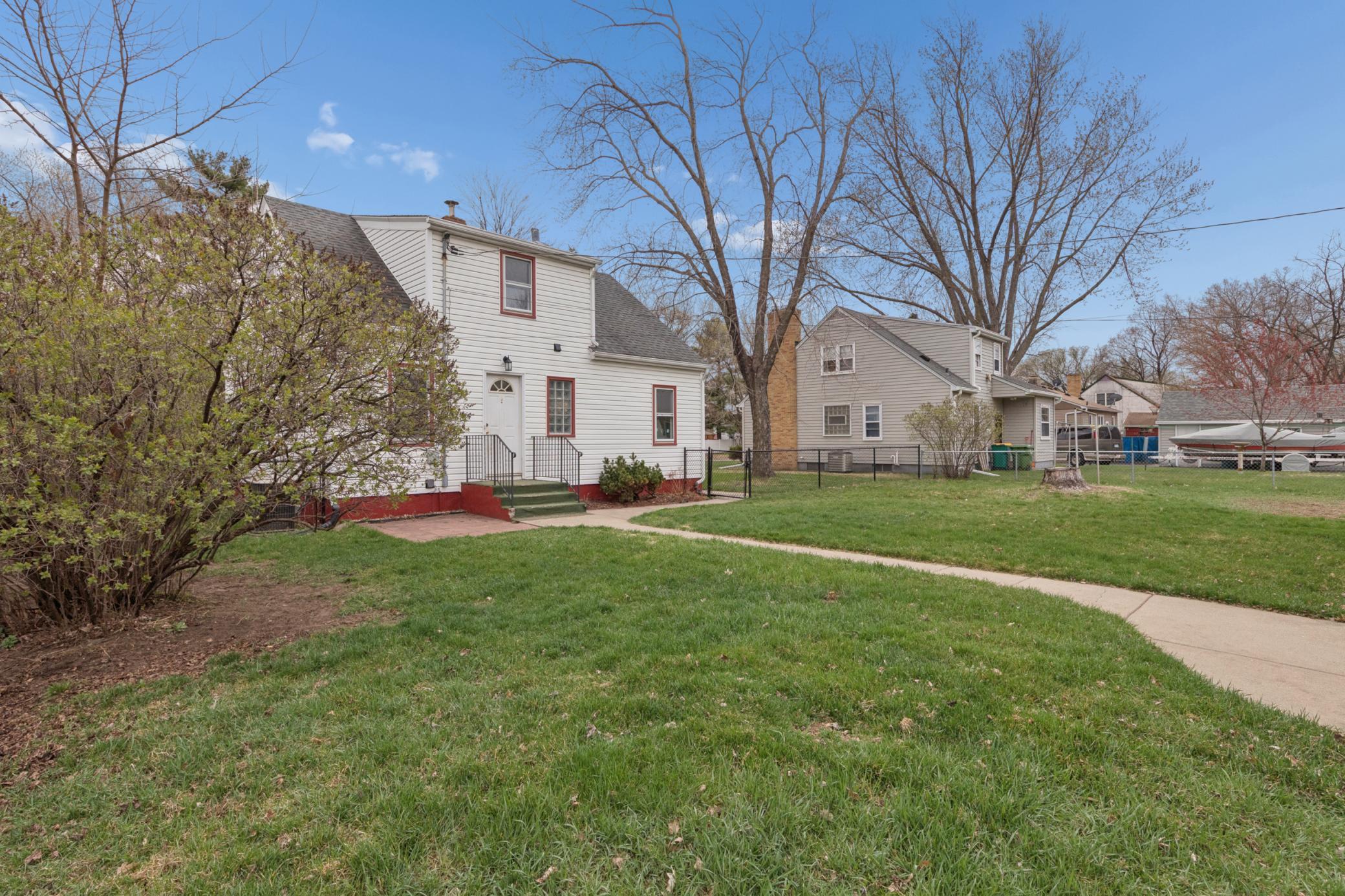Generous backyard with mature trees and open green space—great for outdoor enjoyment.