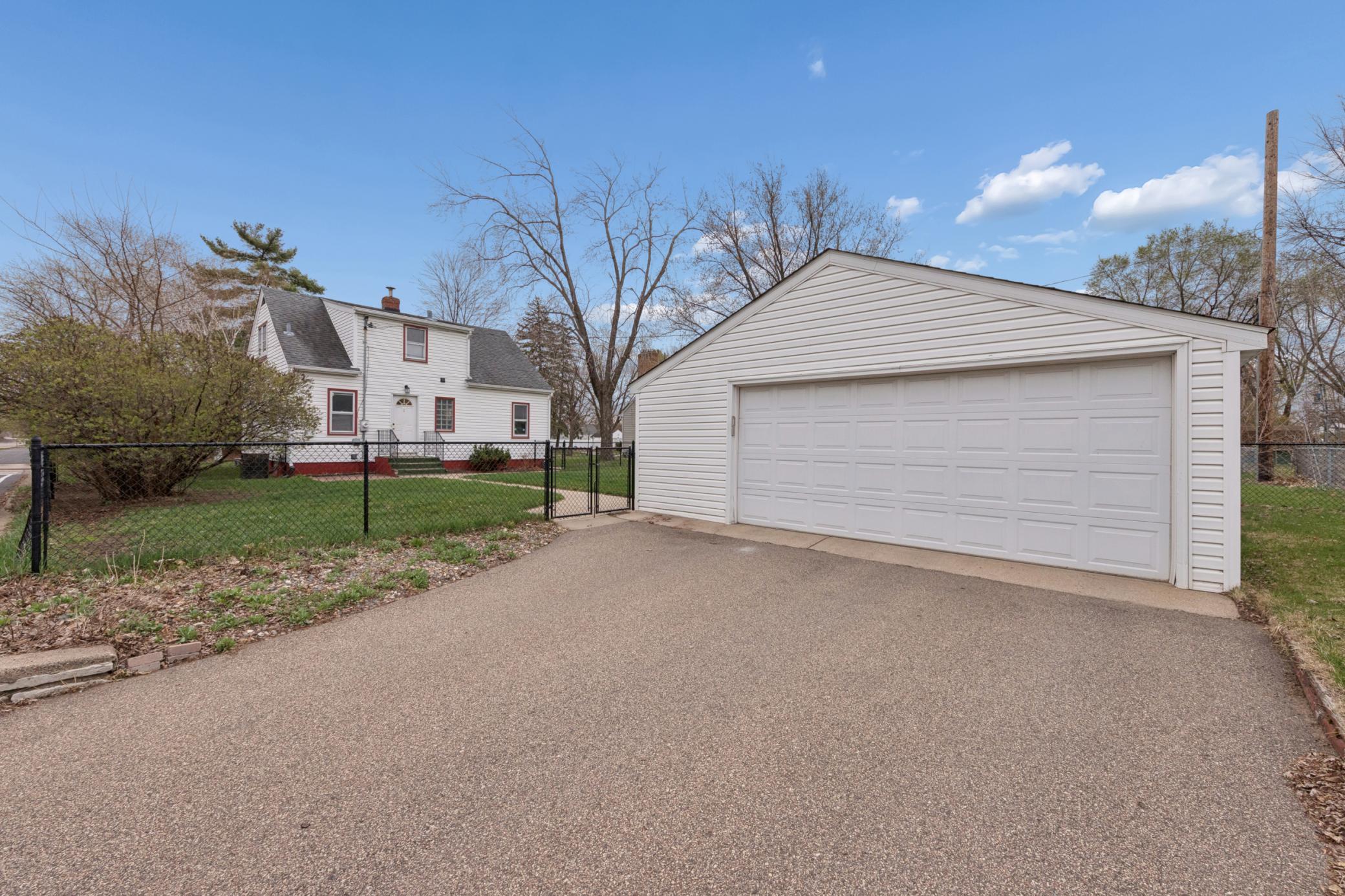Detached two-car garage with spacious driveway and easy access to the backyard.
