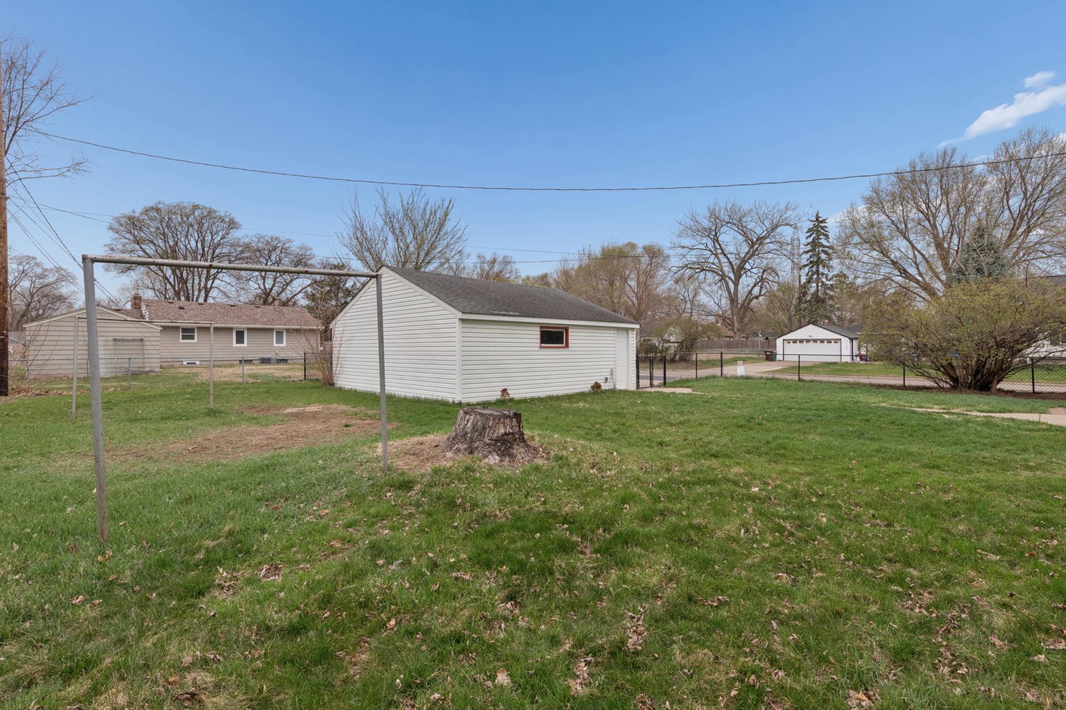 Fully fenced, large backyard with open green space—perfect for entertaining, play, or gardening.