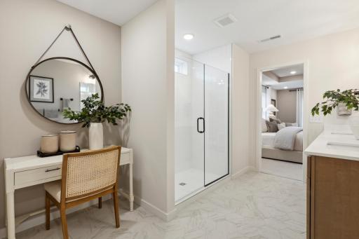 Luxurious owner's bathroom with vanity area