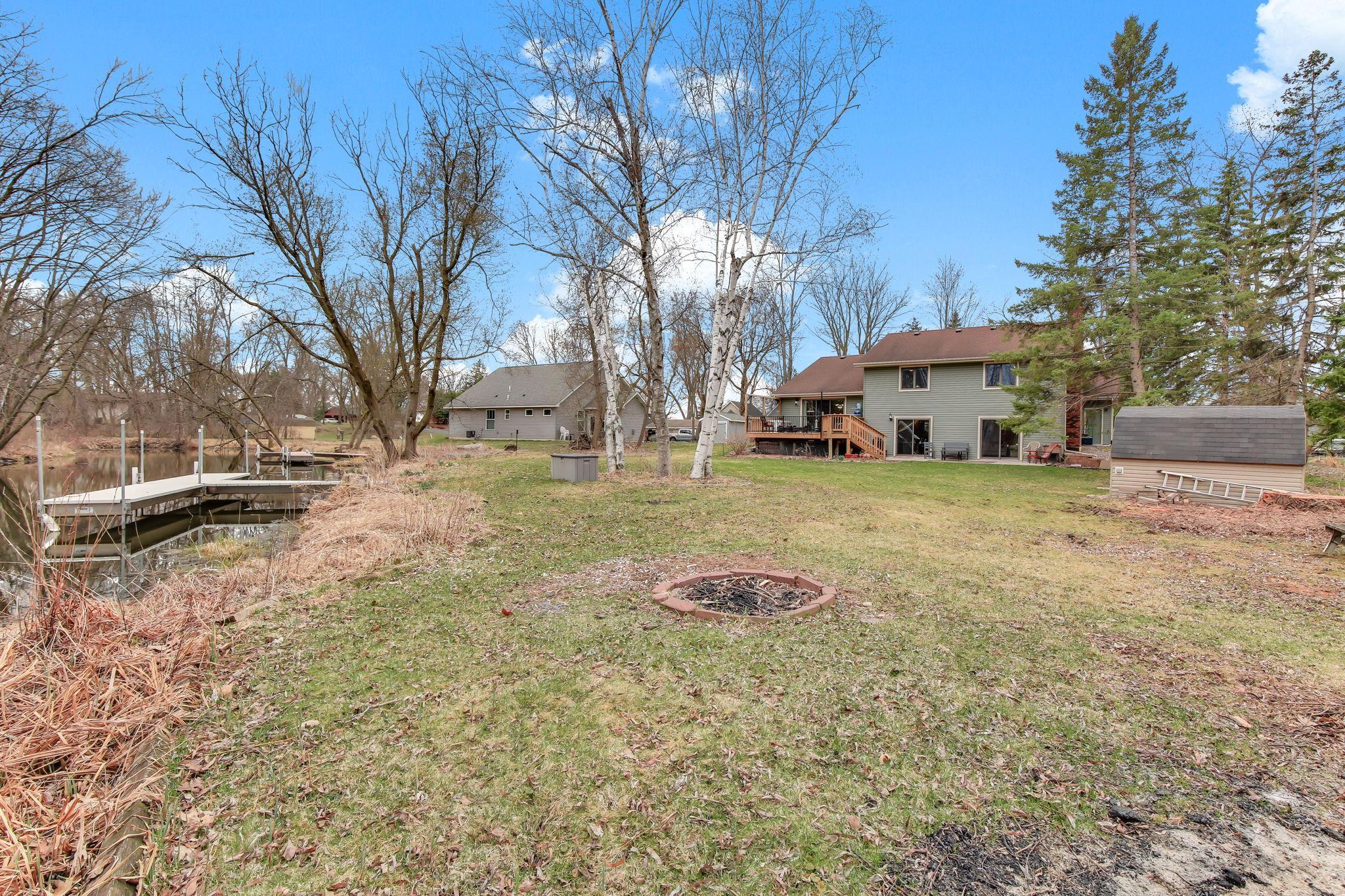Back of home faces the channel with a .40 acre yard fire ring