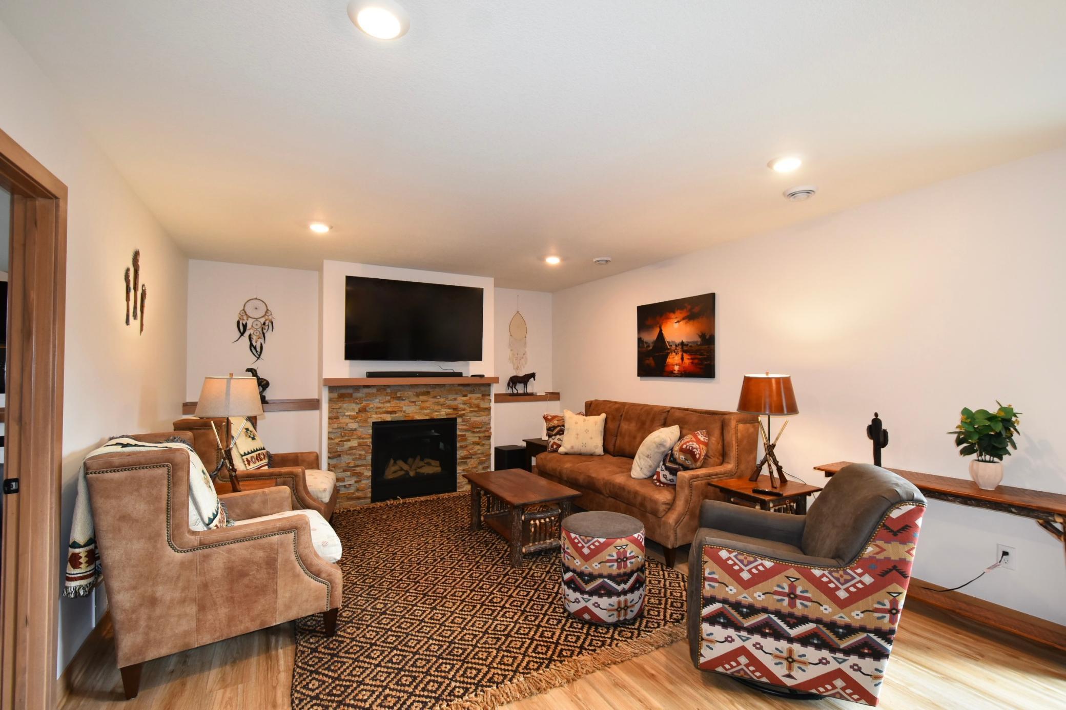 basement living room with gas fireplace