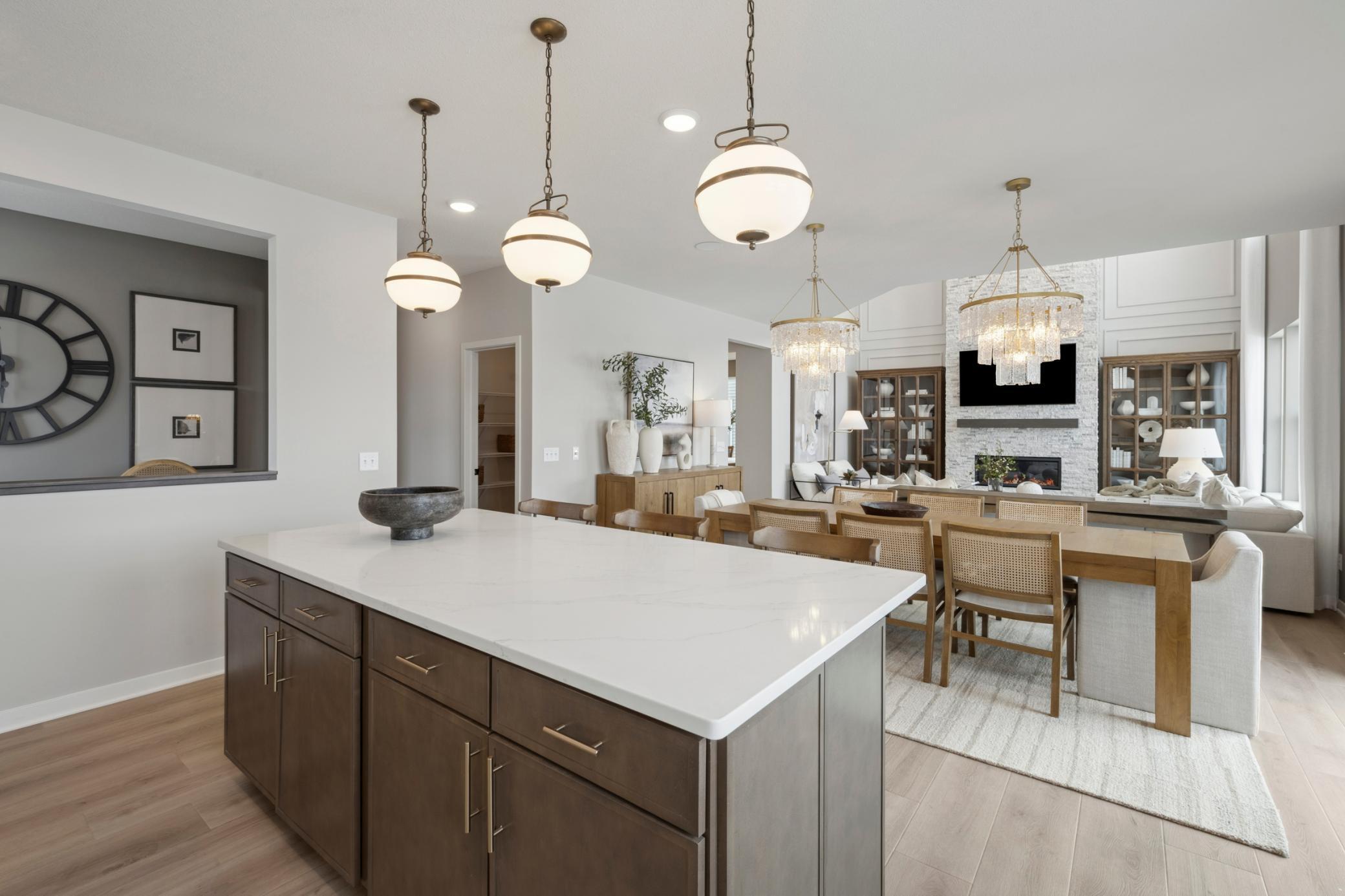 Expansive island with quartz surface offers additional prep space, bar seating, and a stylish centerpiece to your new kitchen.
