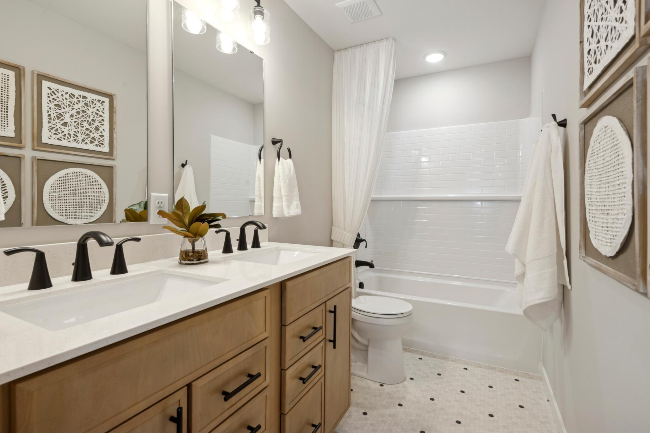 Inviting hall bathroom with dual sinks.