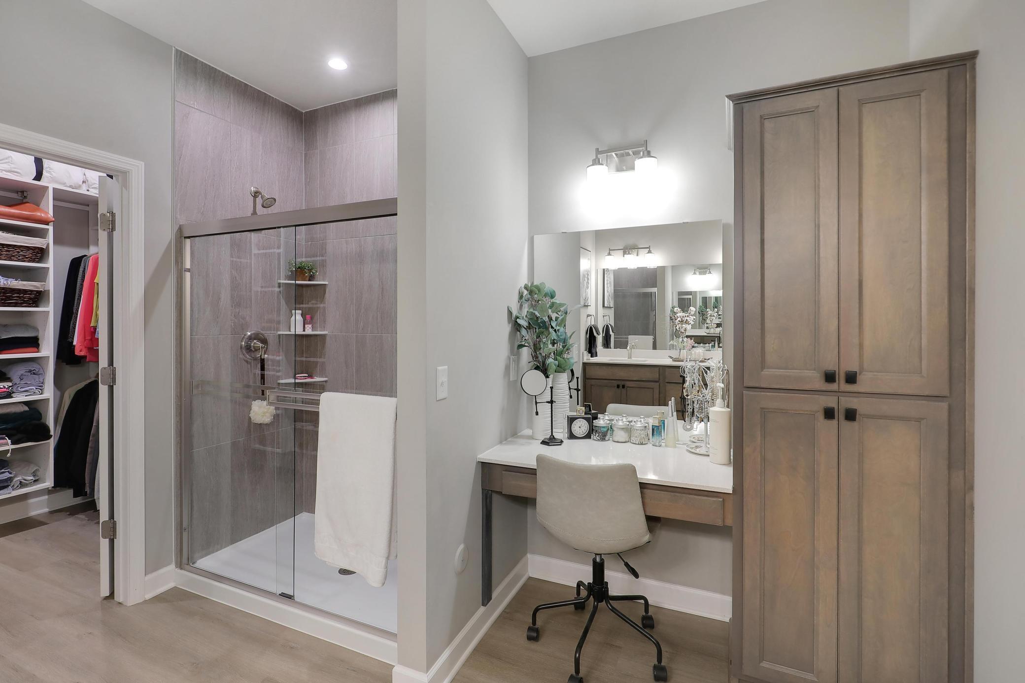 Powder area and shower in the primary bathroom.