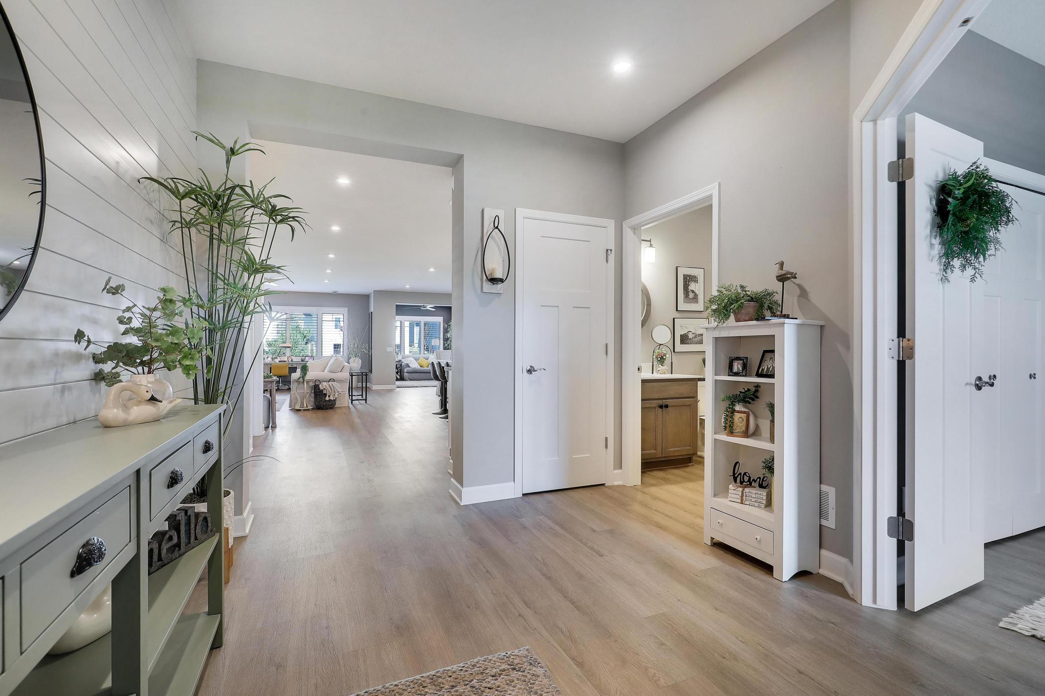 Wide entryway that leads to the open concept living areas. 2nd bedroom and full bathroom are to the right.