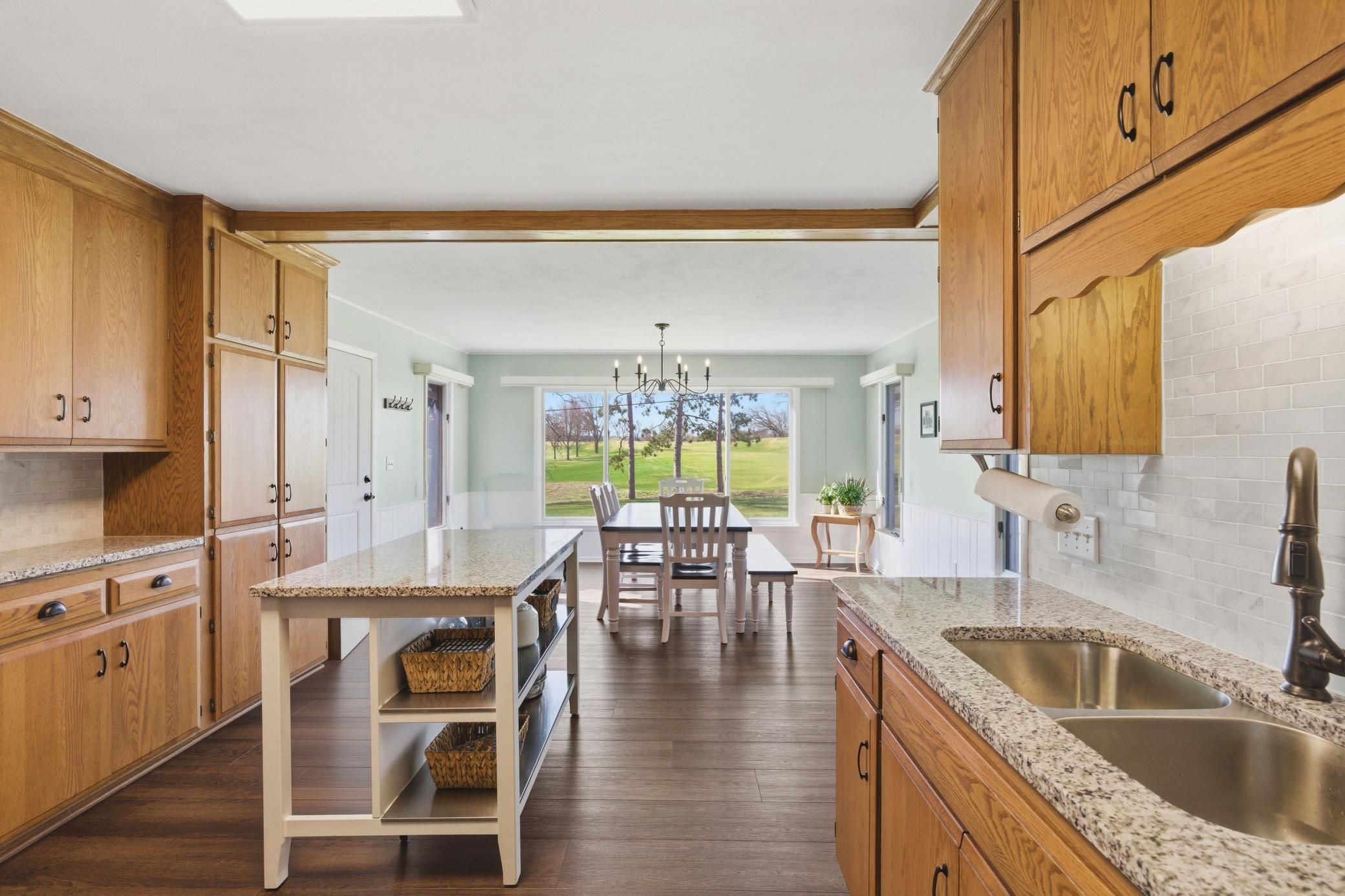 Floating island stays with home plus granite counter tops and tile backsplash