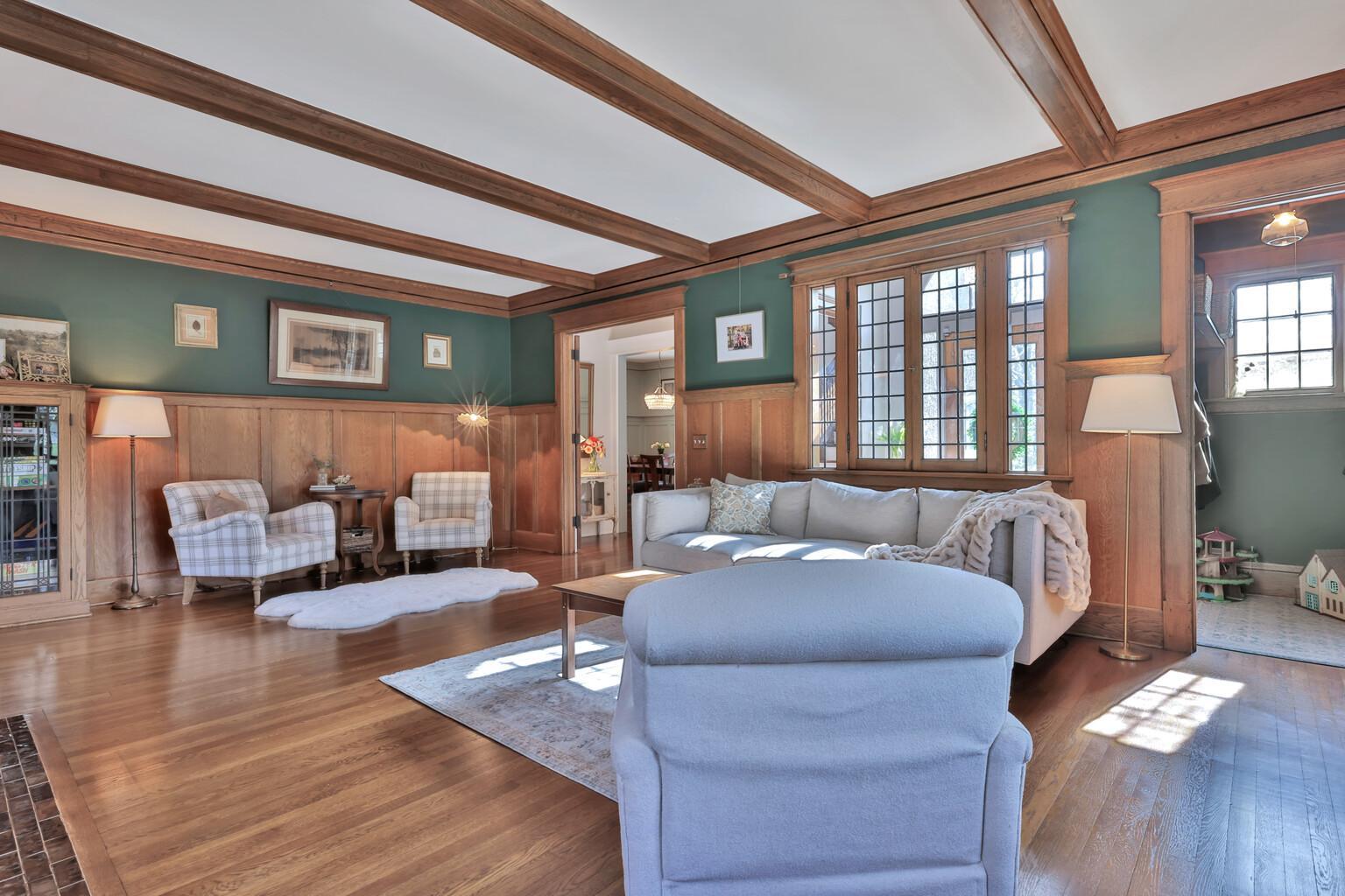Spacious and sophisticated! Enjoy the warmth of the gas fireplace framed by custom built-ins and exquisite wood detailing. Dramatic beam ceilings and large windows create a bright, lodge-like feel.
