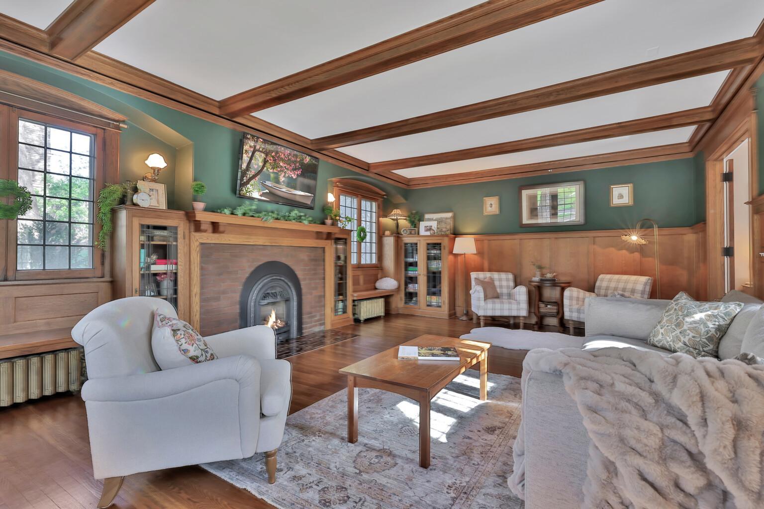 Spacious and sophisticated! Enjoy the warmth of the gas fireplace framed by custom built-ins and exquisite wood detailing. Dramatic beam ceilings and large windows create a bright, lodge-like feel.