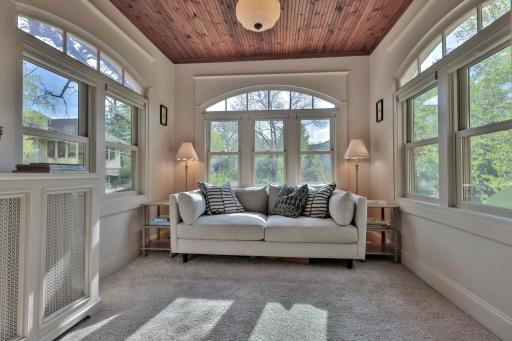 Sun-soaked retreat with a beautiful wood-plank ceiling and elegant arched windows. A bright, versatile space designed for ultimate relaxation.