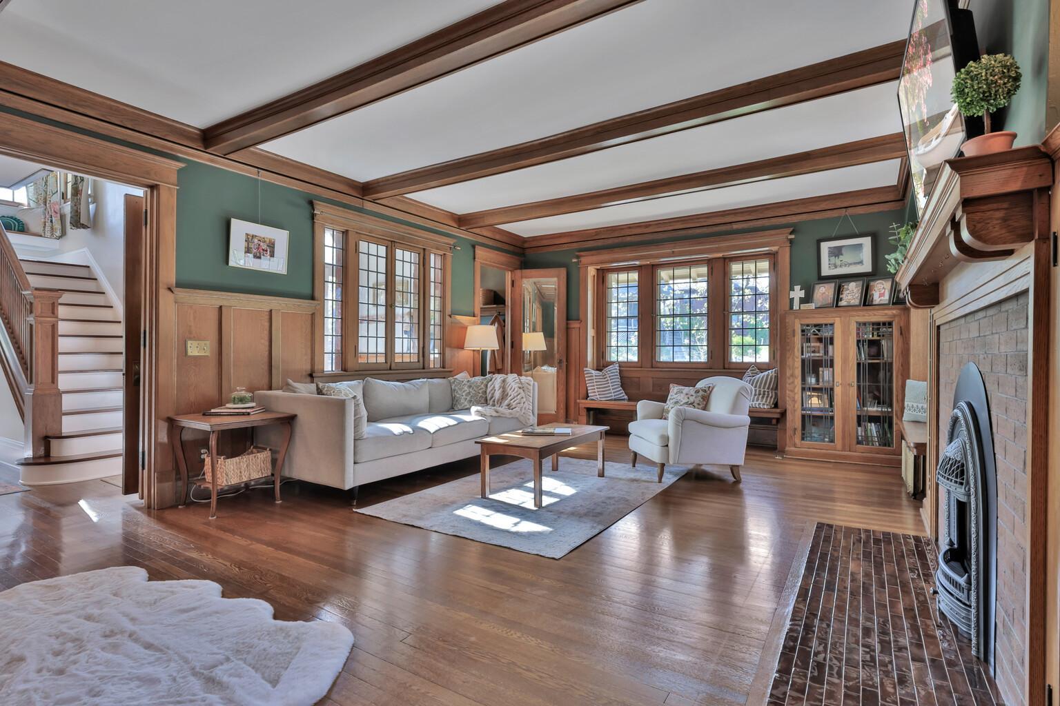Spacious and sophisticated! Enjoy the warmth of the gas fireplace framed by custom built-ins and exquisite wood detailing. Dramatic beam ceilings and large windows create a bright, lodge-like feel.
