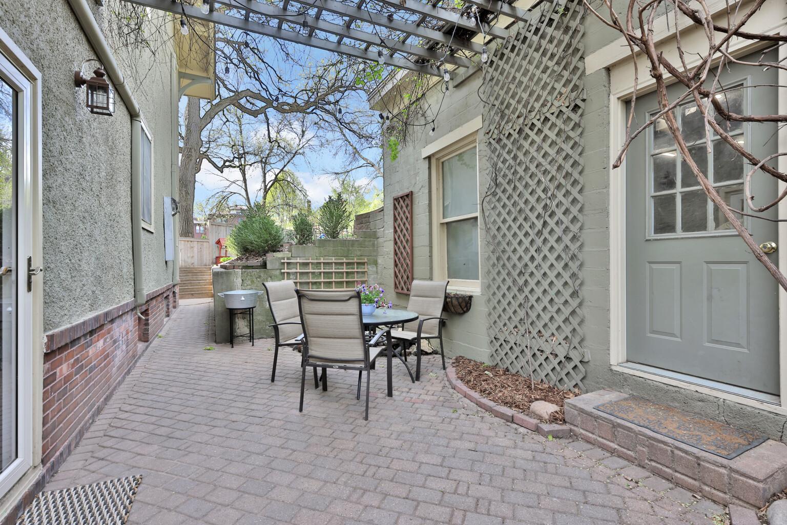 An urban oasis in the heart of the city! Enjoy unmatched privacy in your vine-covered courtyard and koi pond sanctuary. A rare, peaceful escape just steps away from vibrant city living and dining.