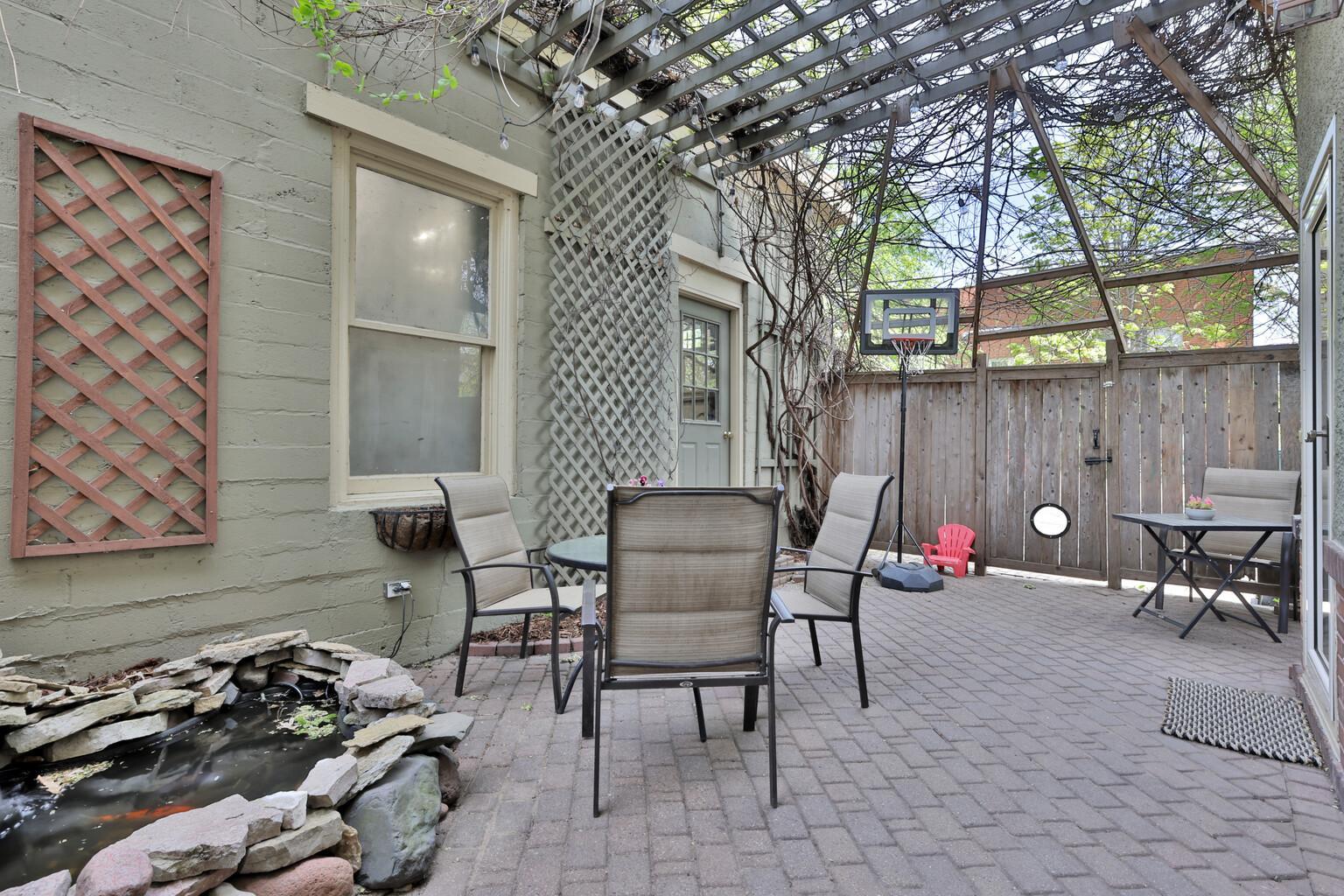 An urban oasis in the heart of the city! Enjoy unmatched privacy in your vine-covered courtyard and koi pond sanctuary. A rare, peaceful escape just steps away from vibrant city living and dining.