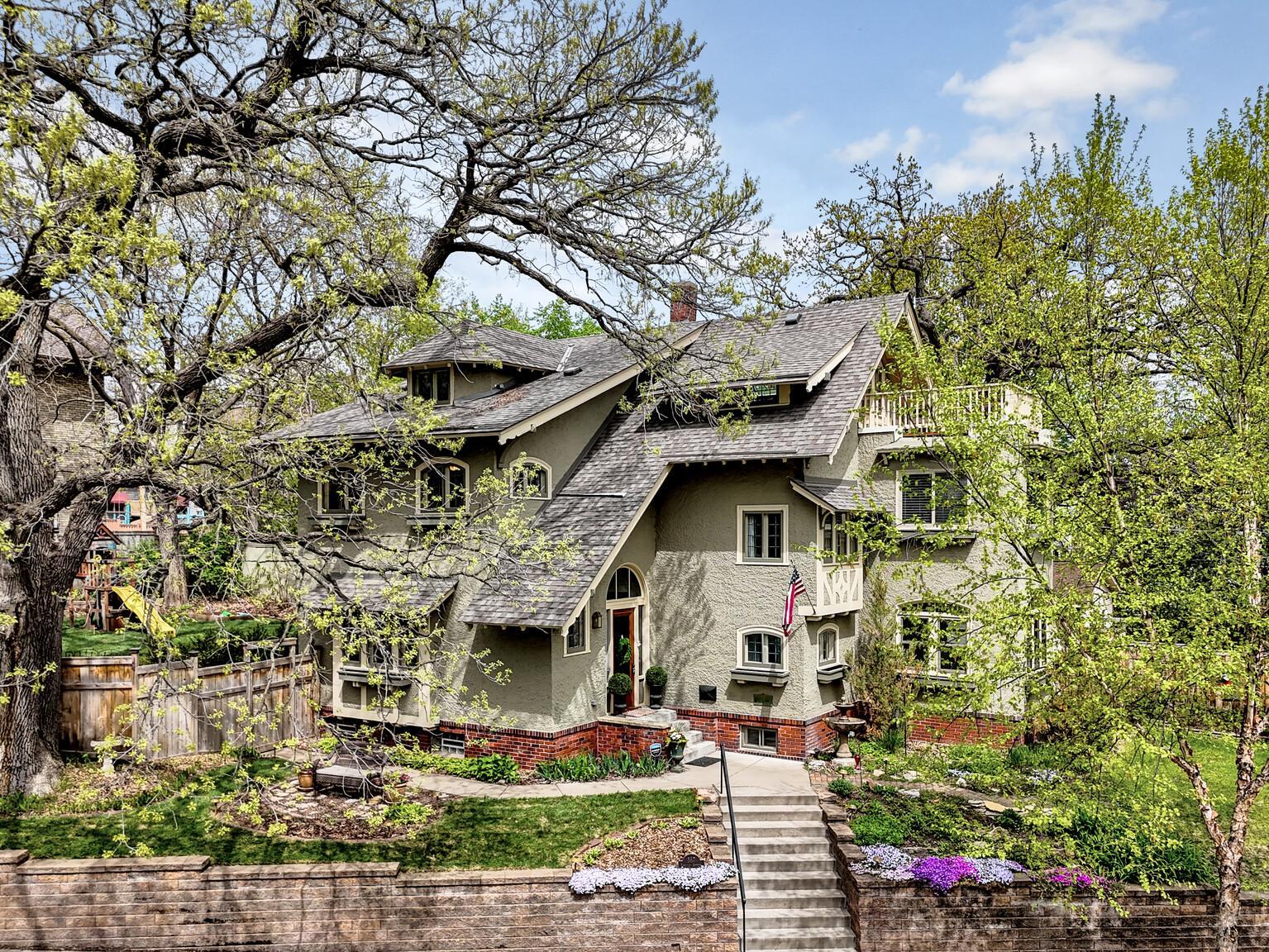 A spectacular first impression! An extra-long, gently sloped sidewalk leads you toward this historic masterpiece. Framed by mature oaks, the home’s striking gabled architecture and timeless charm are on full display.