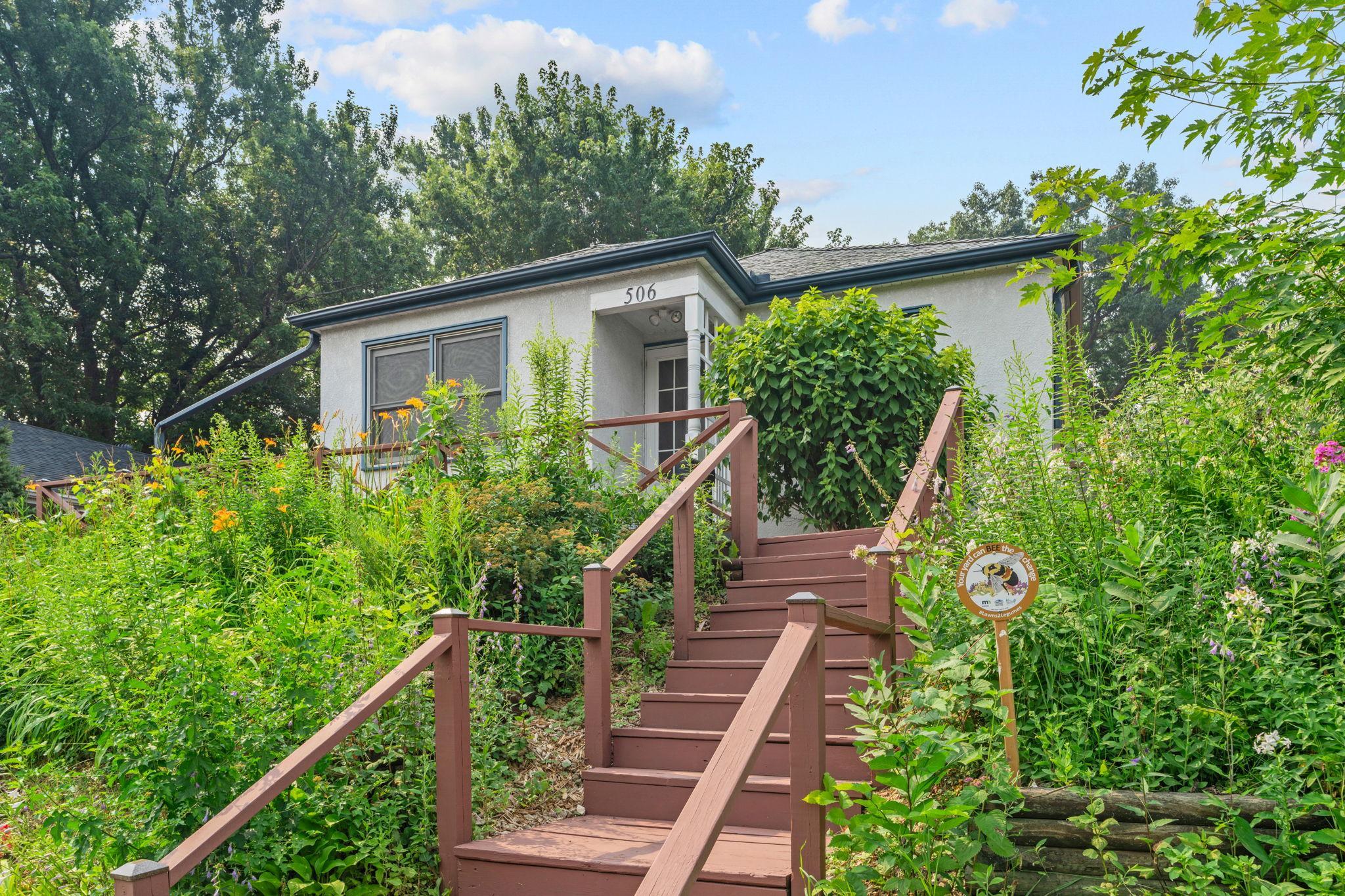 Just outside your front door is a phenomenal front porch and maintenance free pollinator garden.