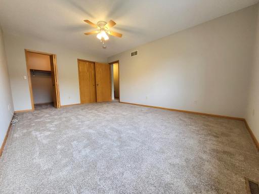 Upper level primary bedroom with walk-in closet