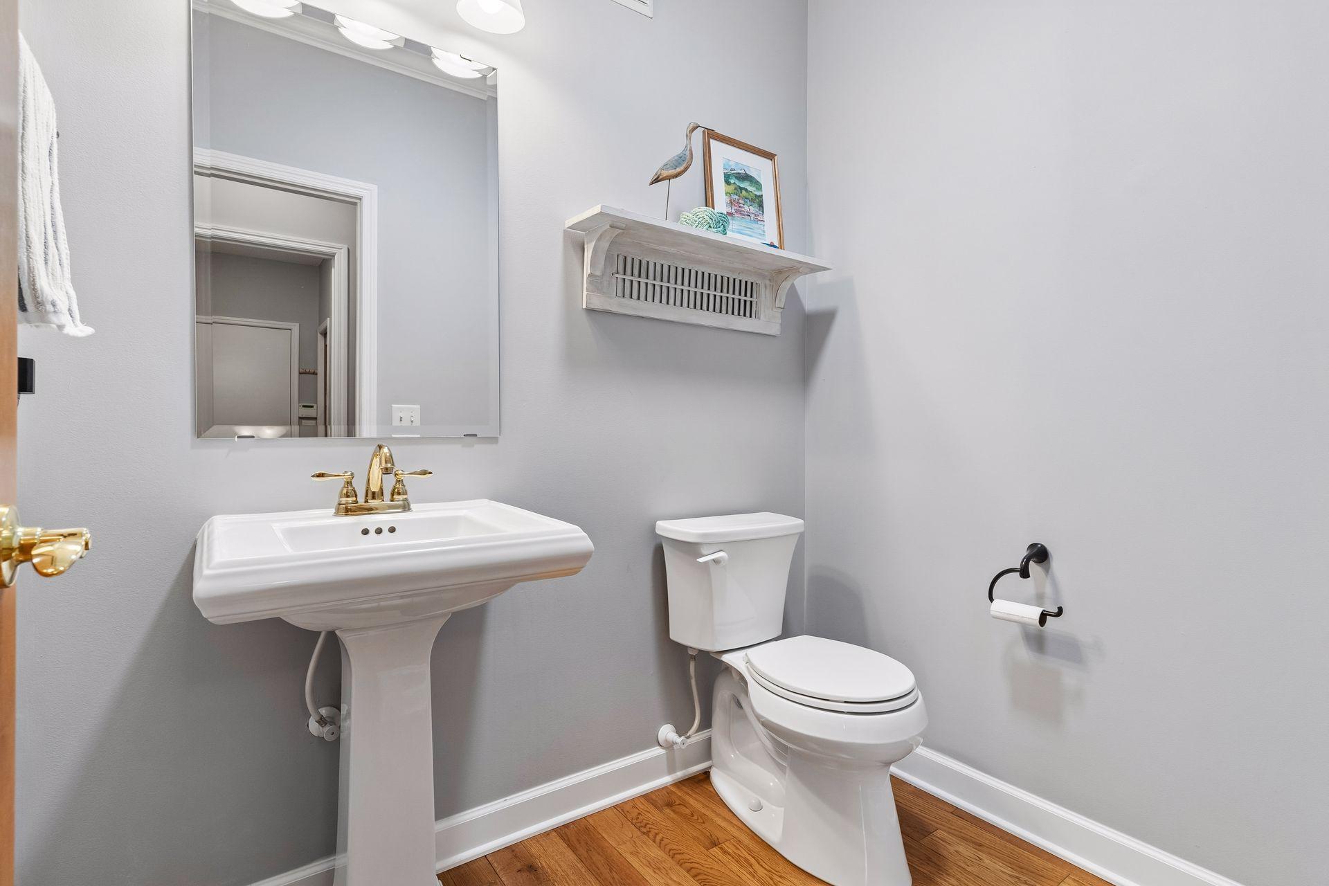 The Powder Room features updated fixtures and a new toilet.