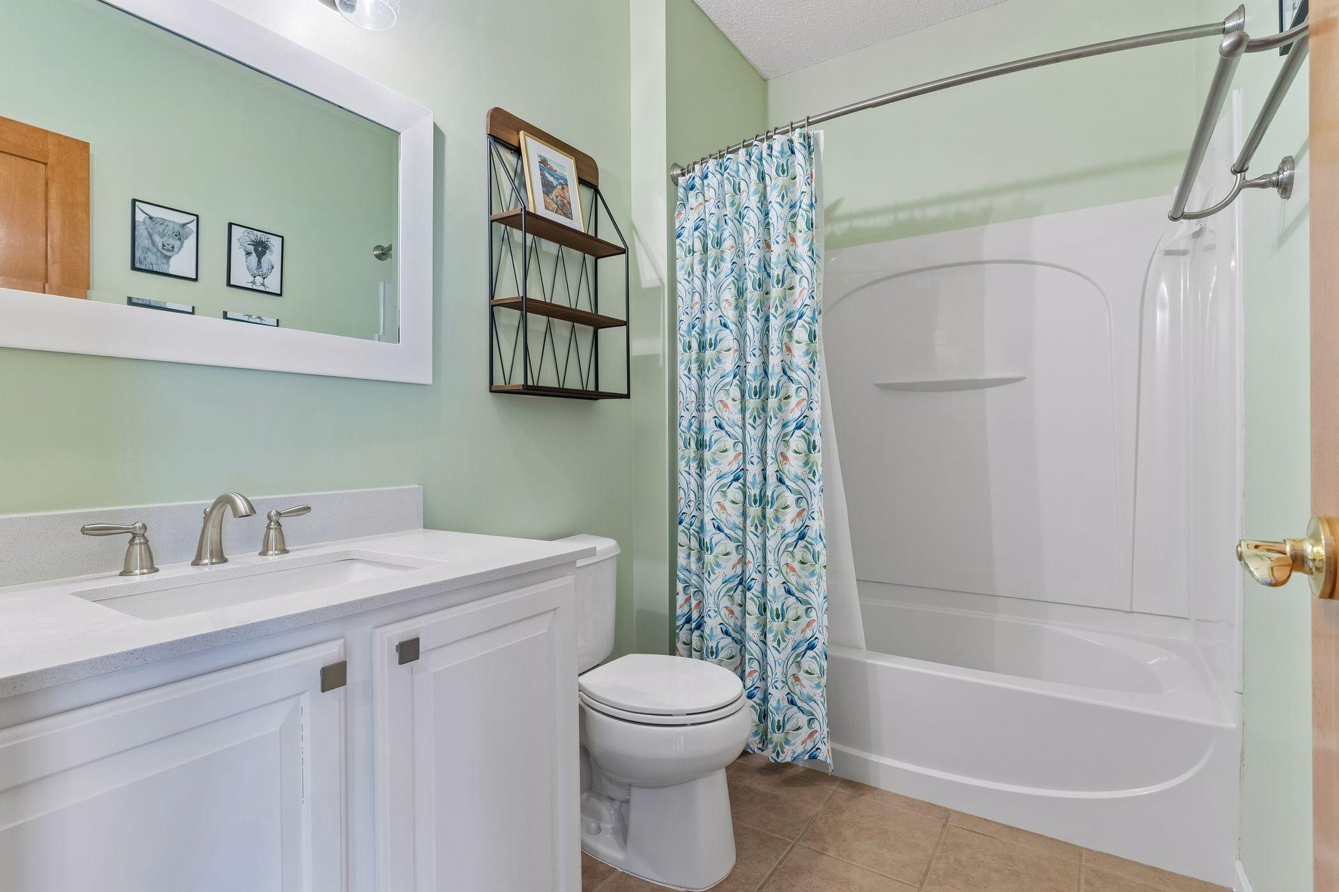 The full, lower level bathroom offers updated fixtures and tiled flooring.