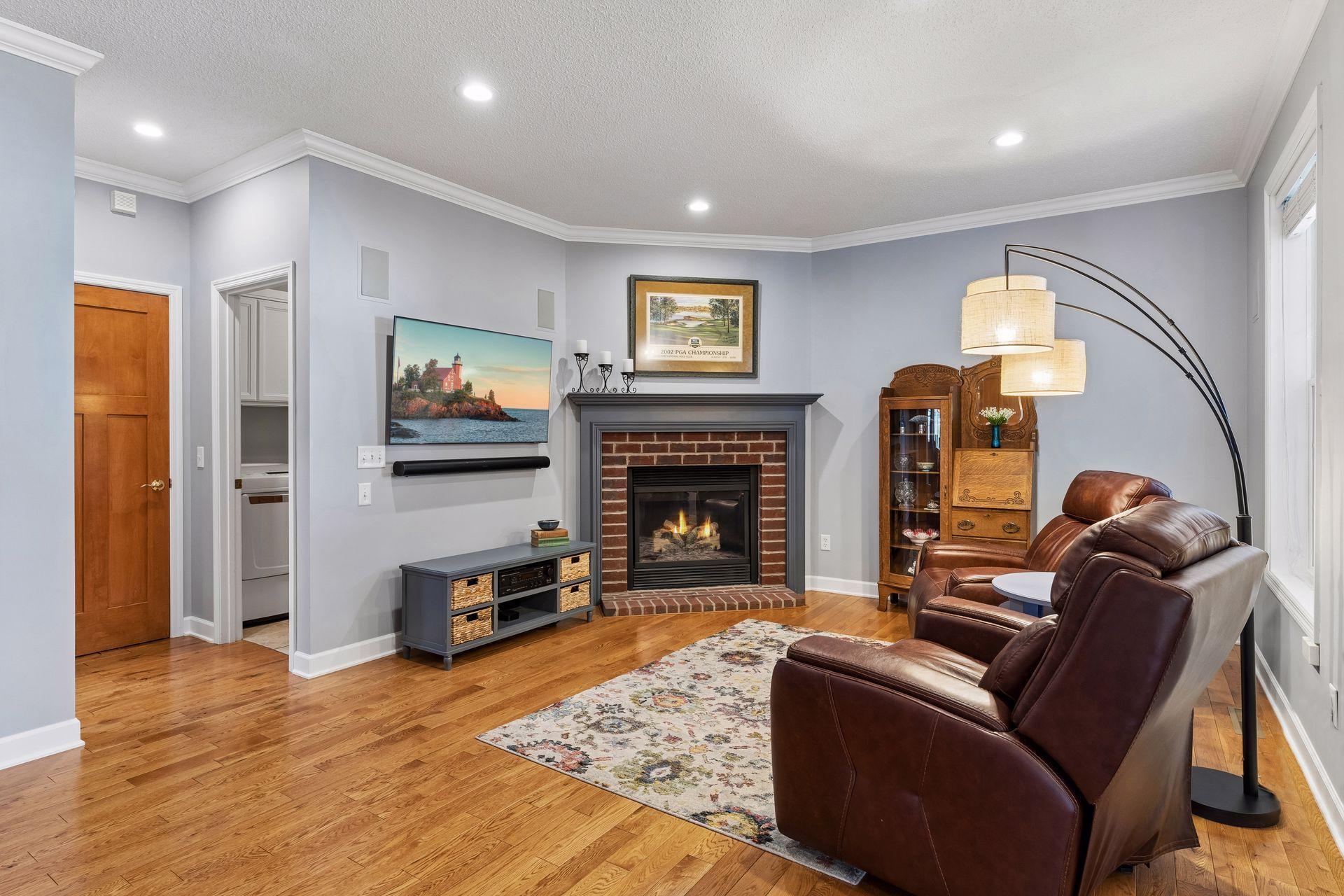 The inviting Den features a gas burning fireplace and built-in speakers.