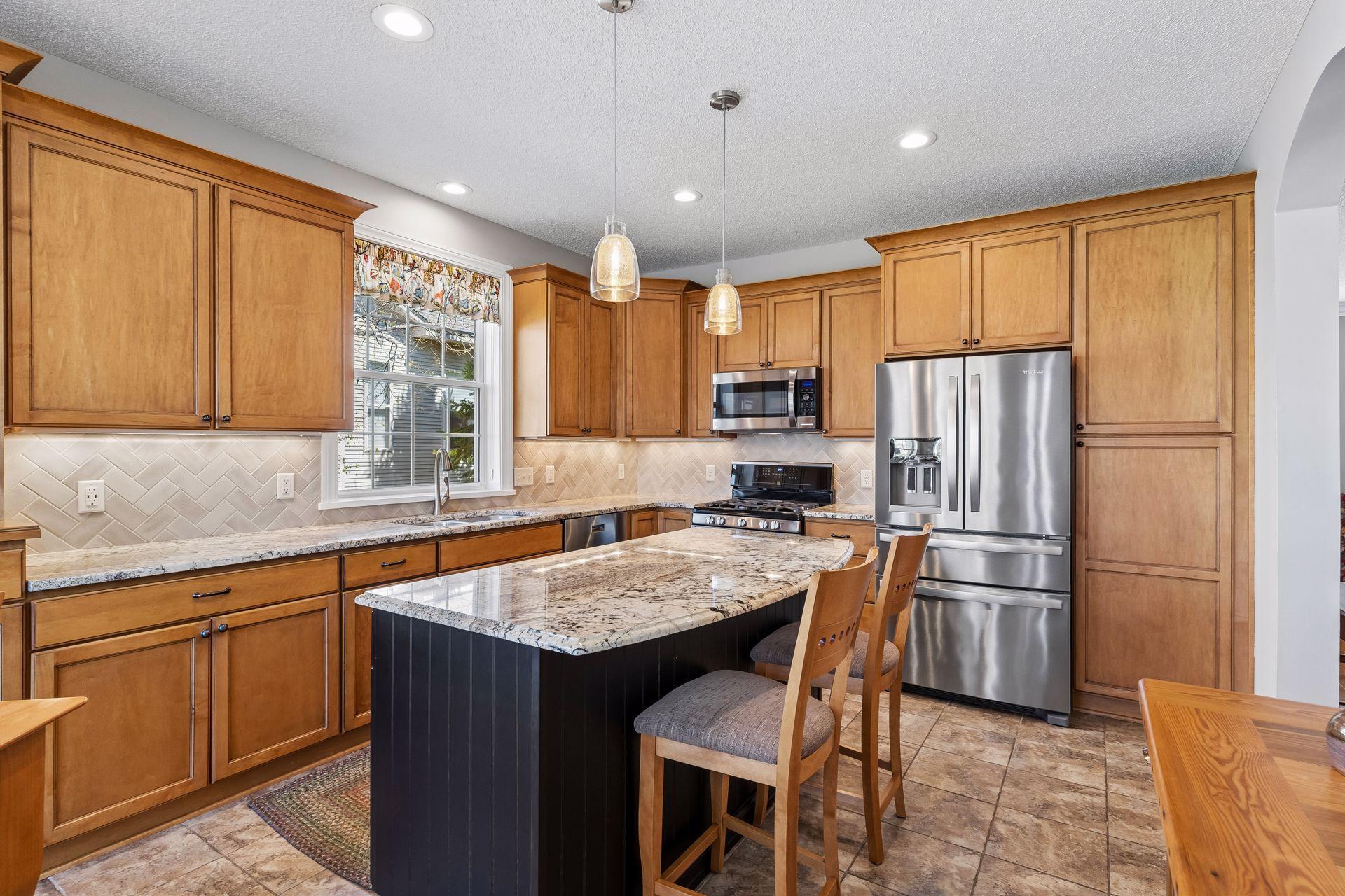 Well-equipped, this large Kitchen offers custom cabinetry with soft-close drawers, roll-out shelving and a large island for everyone to gather around.