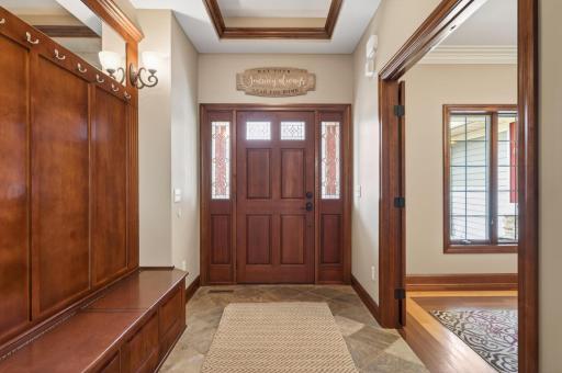 foyer, ceramic flooring, coffer ceiling with crown molding