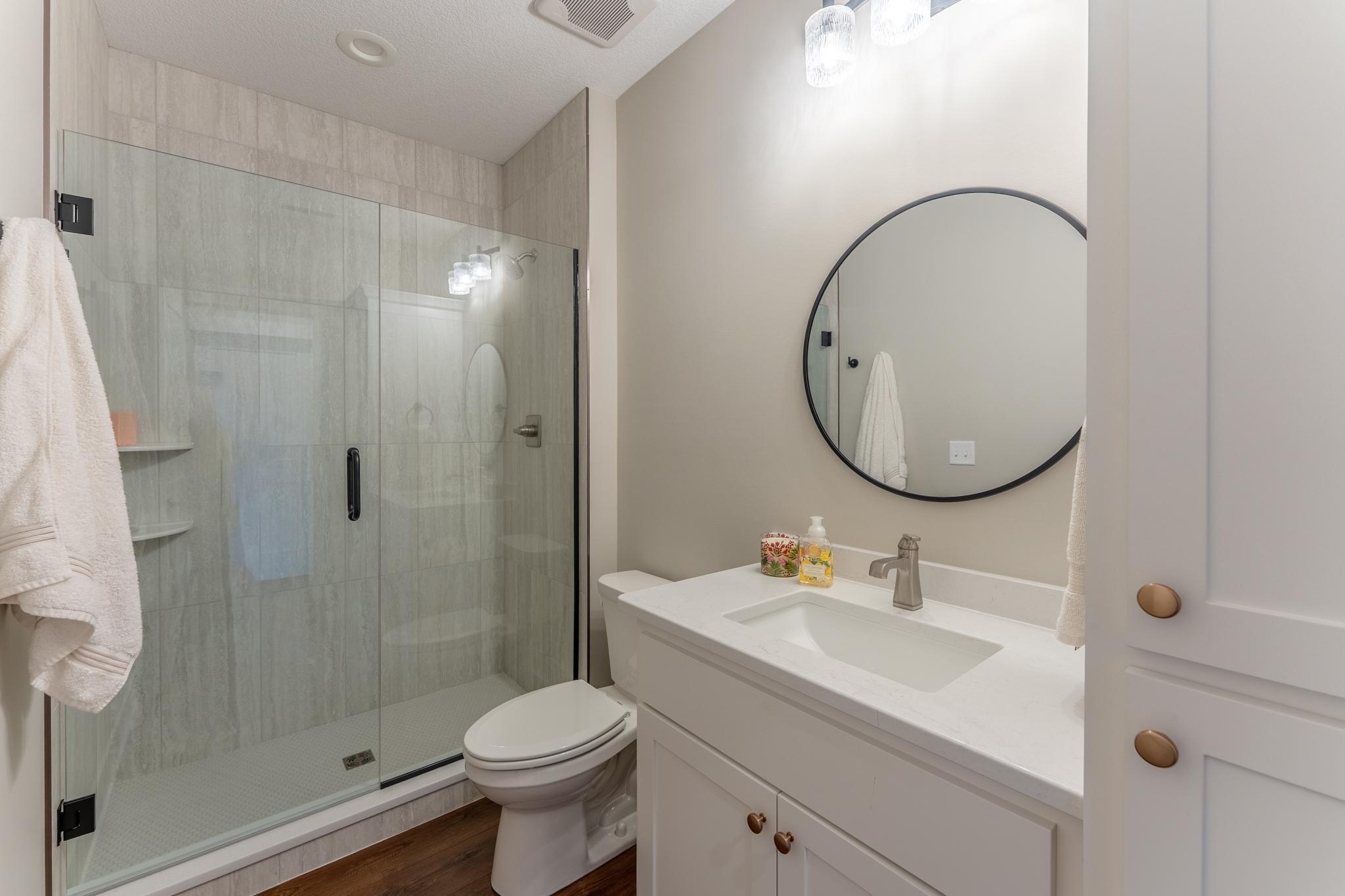 Lower level bathroom has generous fully tiled, walk in shower.