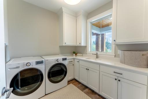 Main floor laundry is well appointed with extra storage.