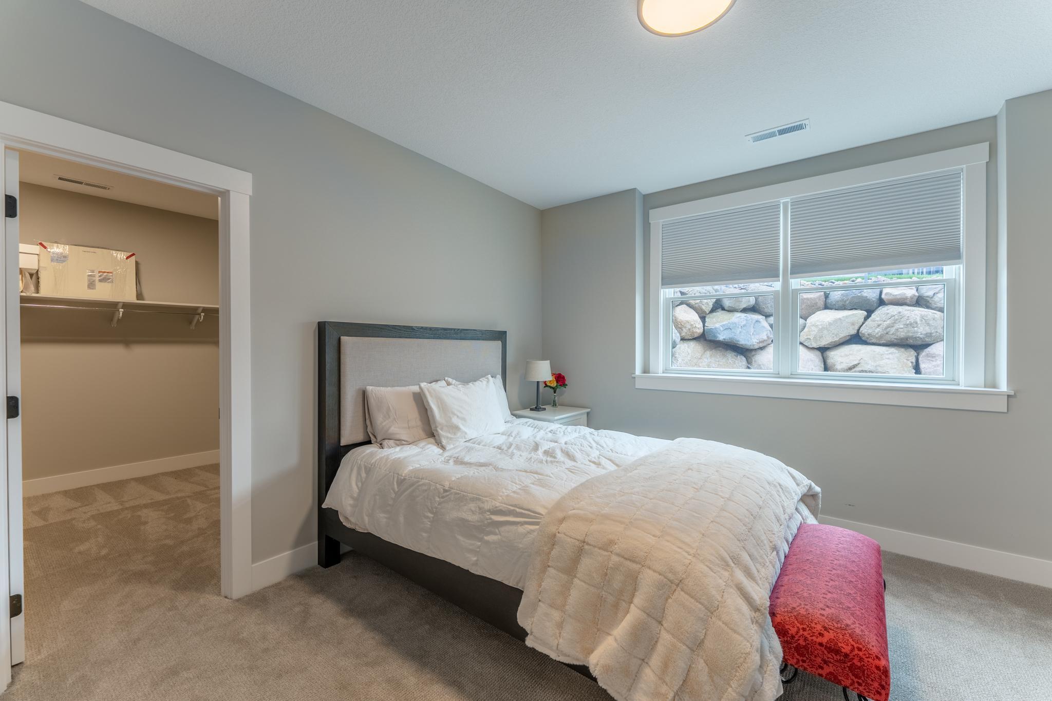 One of three bedrooms on this level. This bedroom has a spacious walk in closet and walks through to a full bath.