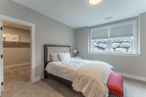 One of three bedrooms on this level. This bedroom has a spacious walk in closet and walks through to a full bath.