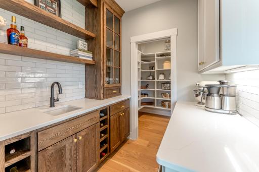 The butler's pantry serves as both an extra meal prep station and a sophisticated main floor bar. A hardworking, beautifully designed space that adapts to your lifestyle and entertaining needs.