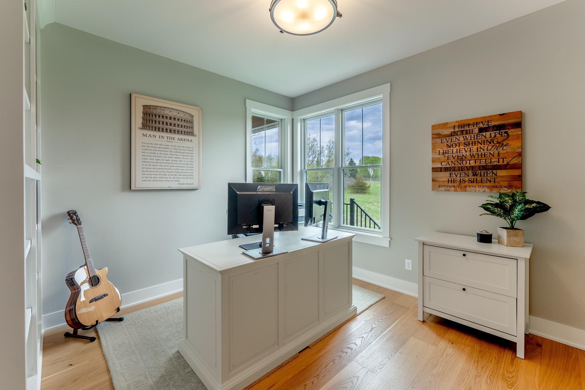 The bright, private home office with corner windows and peaceful views is the perfect work-from-home retreat that inspires focus and creativity.