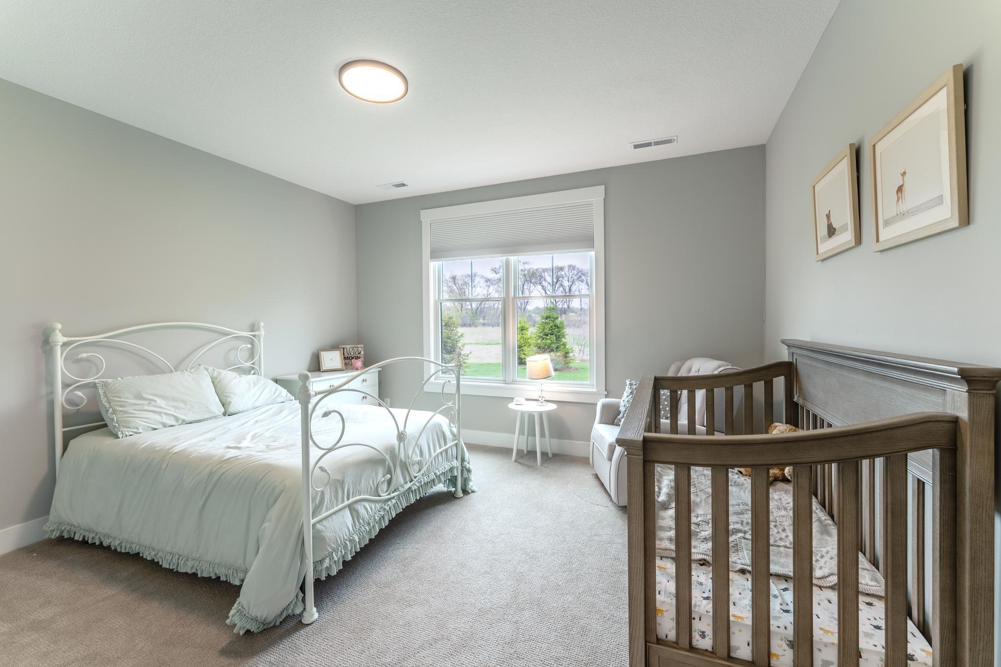Second bedroom on this level is spacious and large window lets in plenty of natural light.