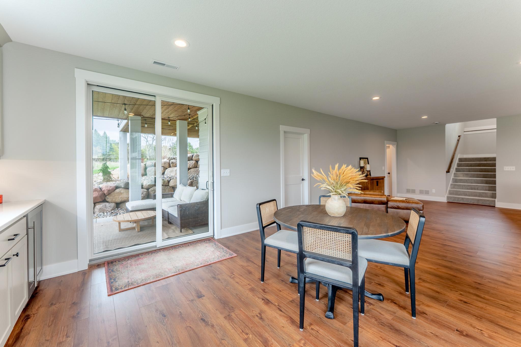 Slide open the doors and step onto a private covered patio framed by a stunning boulder wall. Indoor-outdoor living at its most effortless and inviting.