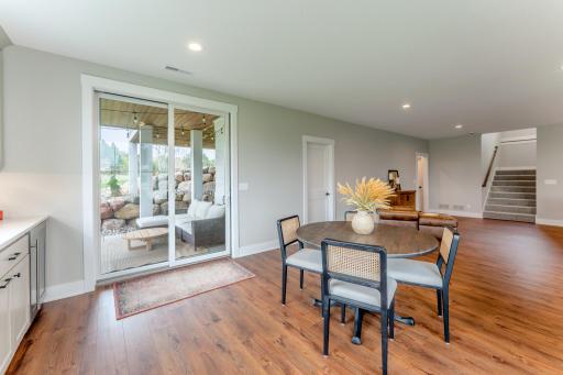 Slide open the doors and step onto a private covered patio framed by a stunning boulder wall. Indoor-outdoor living at its most effortless and inviting.