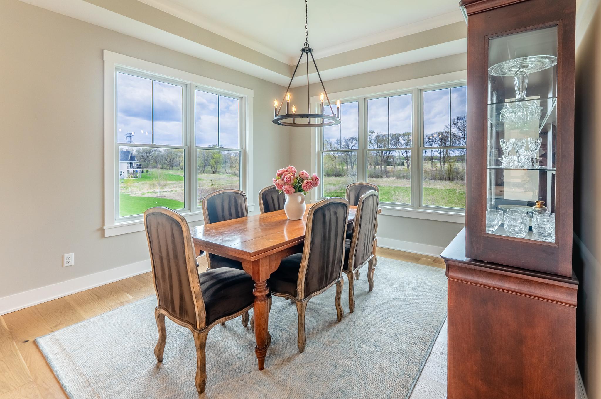 Bathed in natural light from panoramic windows with serene countryside views, this elegant dining room is made for dinner parties, holiday gatherings, and everyday moments worth savoring.