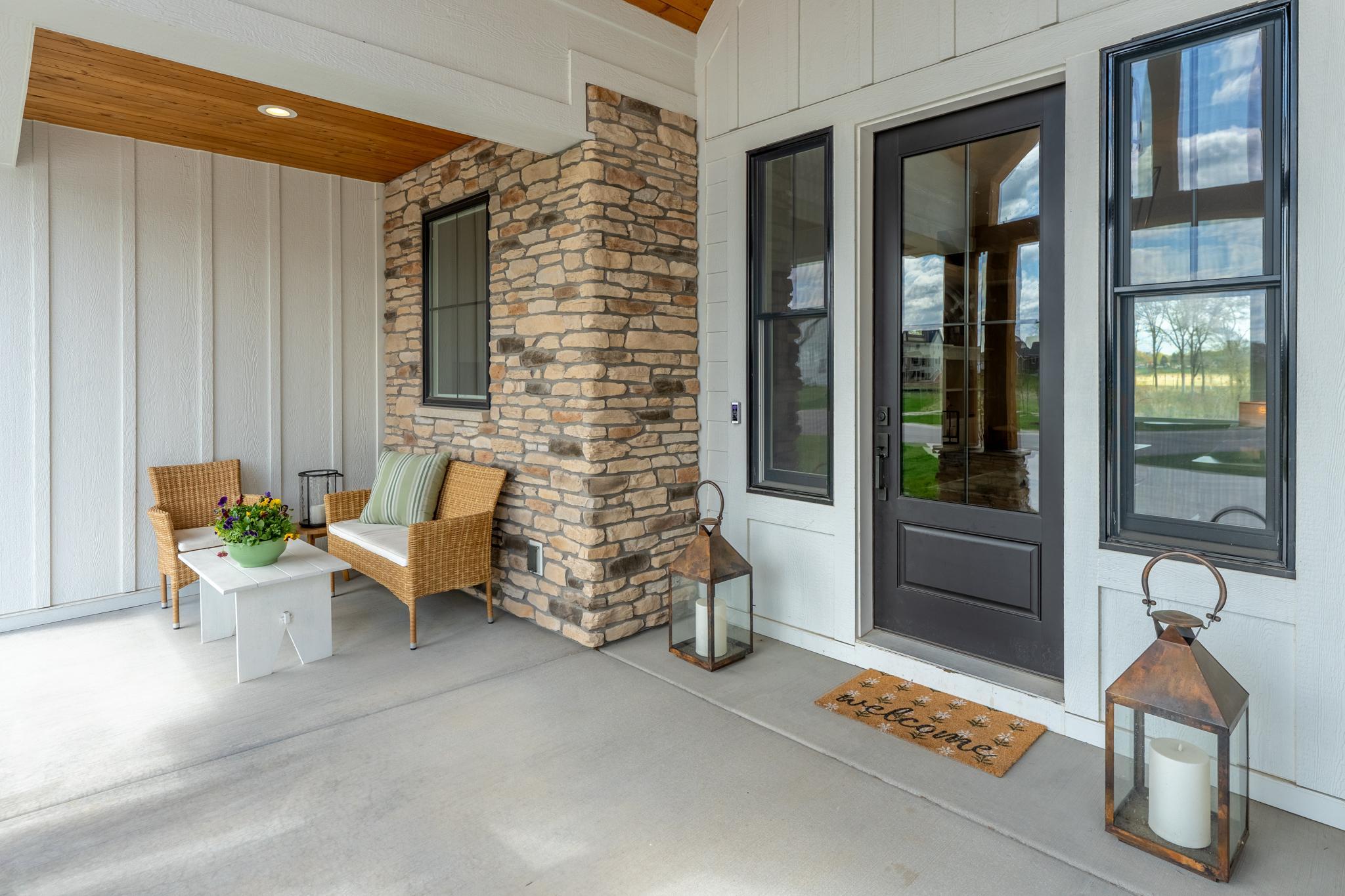 Charming front porch with brick and cedar details welcome your guests.