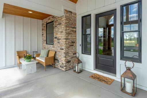Charming front porch with brick and cedar details welcome your guests.