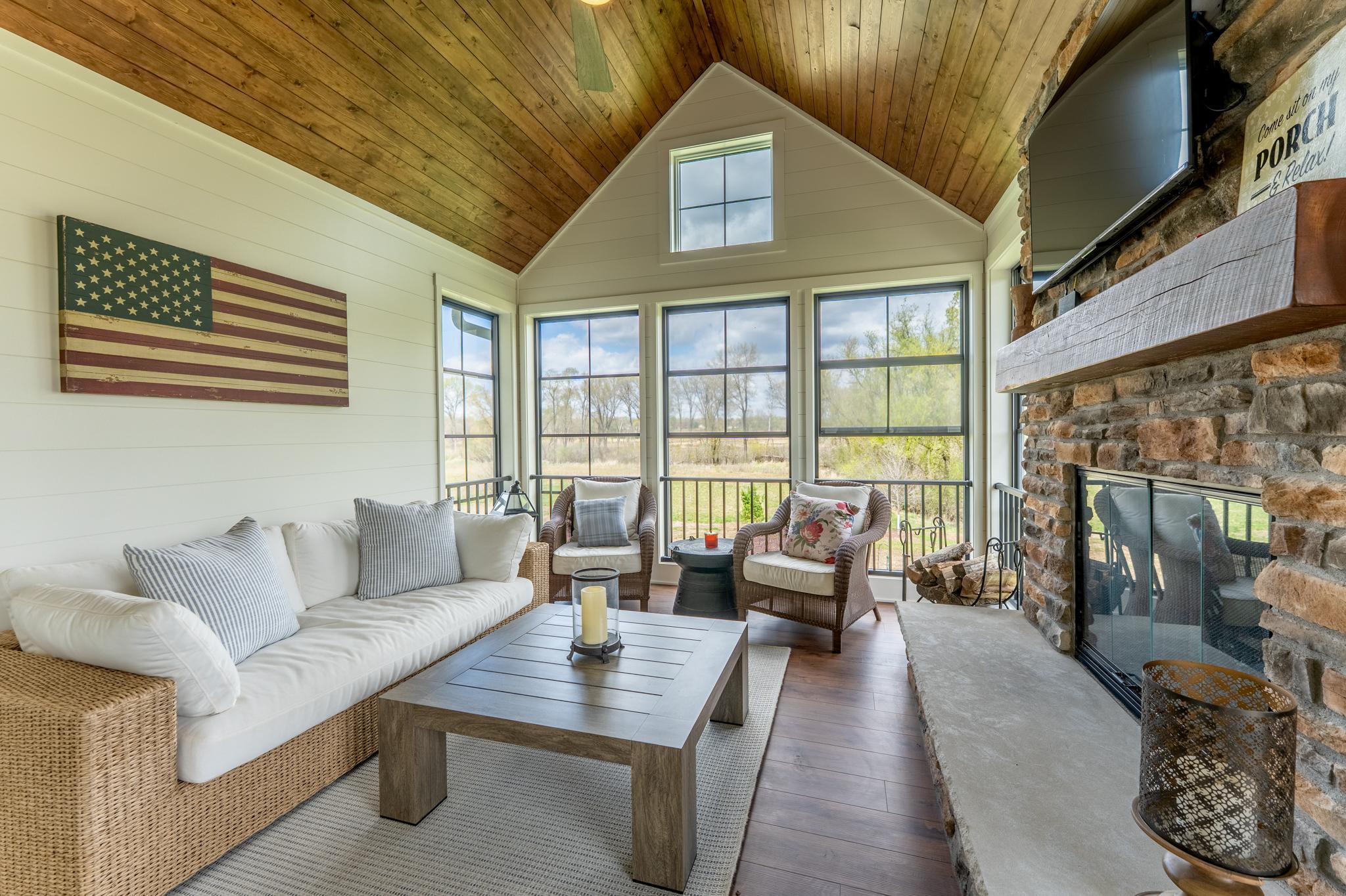 The EZ-breeze windows protect you and your furniture from the elements and along with the fireplace, make this room's use extend beyond the typical 3-season porch.