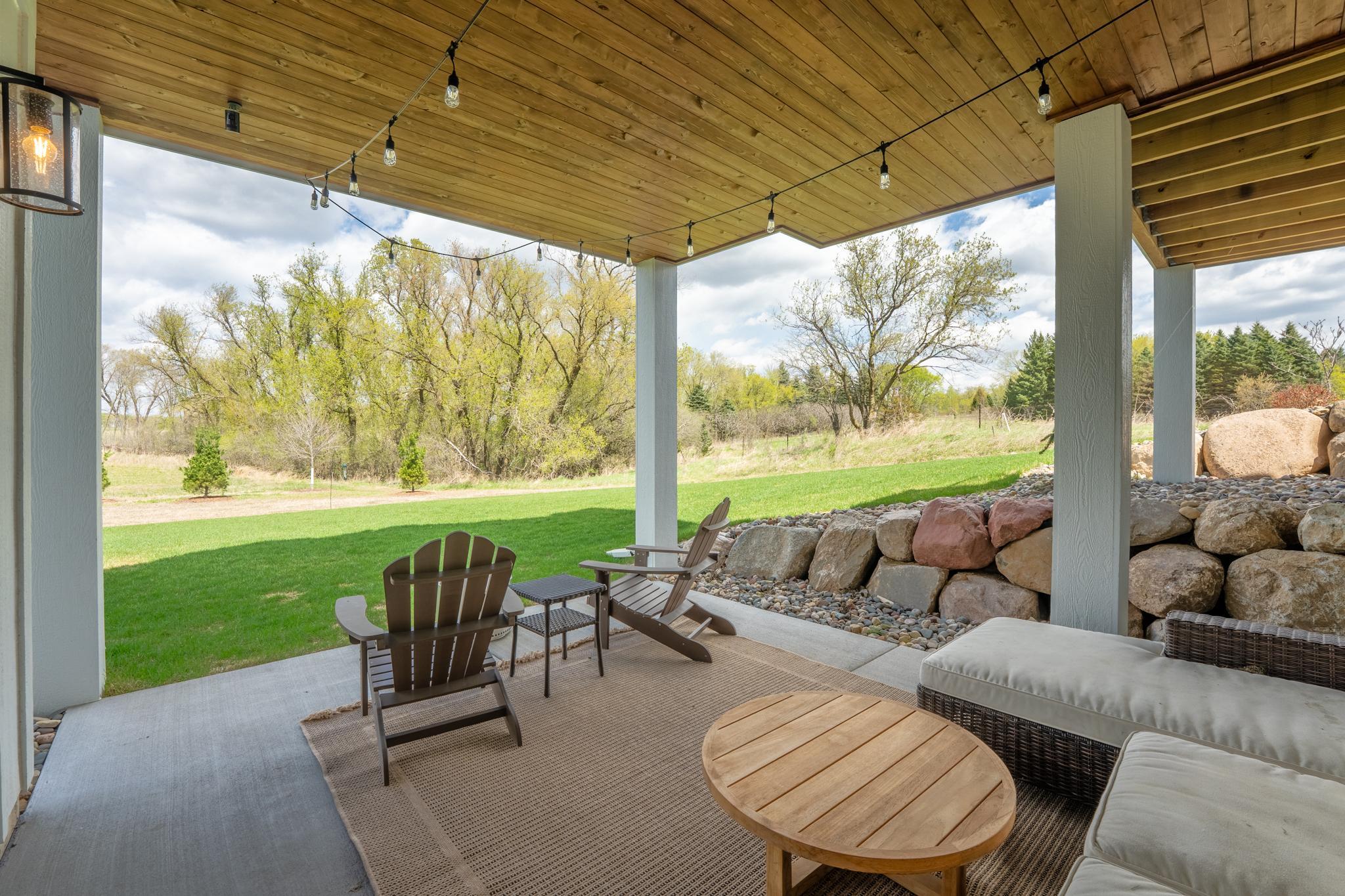 Warm cedar ceilings, boulder charm, and endless green views. This covered patio is the outdoor retreat you never knew you needed.