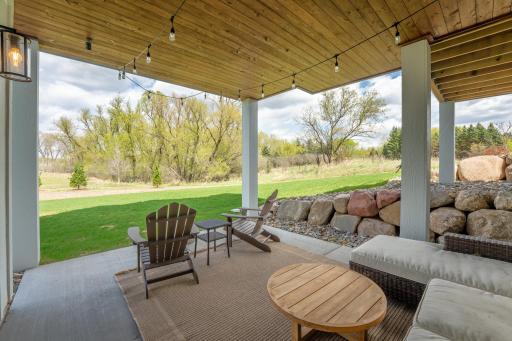Warm cedar ceilings, boulder charm, and endless green views. This covered patio is the outdoor retreat you never knew you needed.