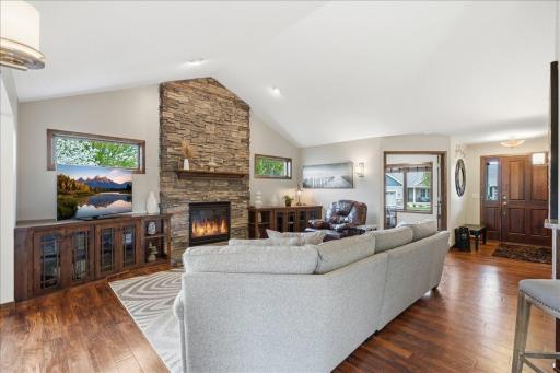 Welcome In! Stunning floors and stone fireplace surround greet you!