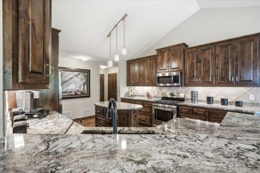 Stunning countertops and dark wood cabinets.