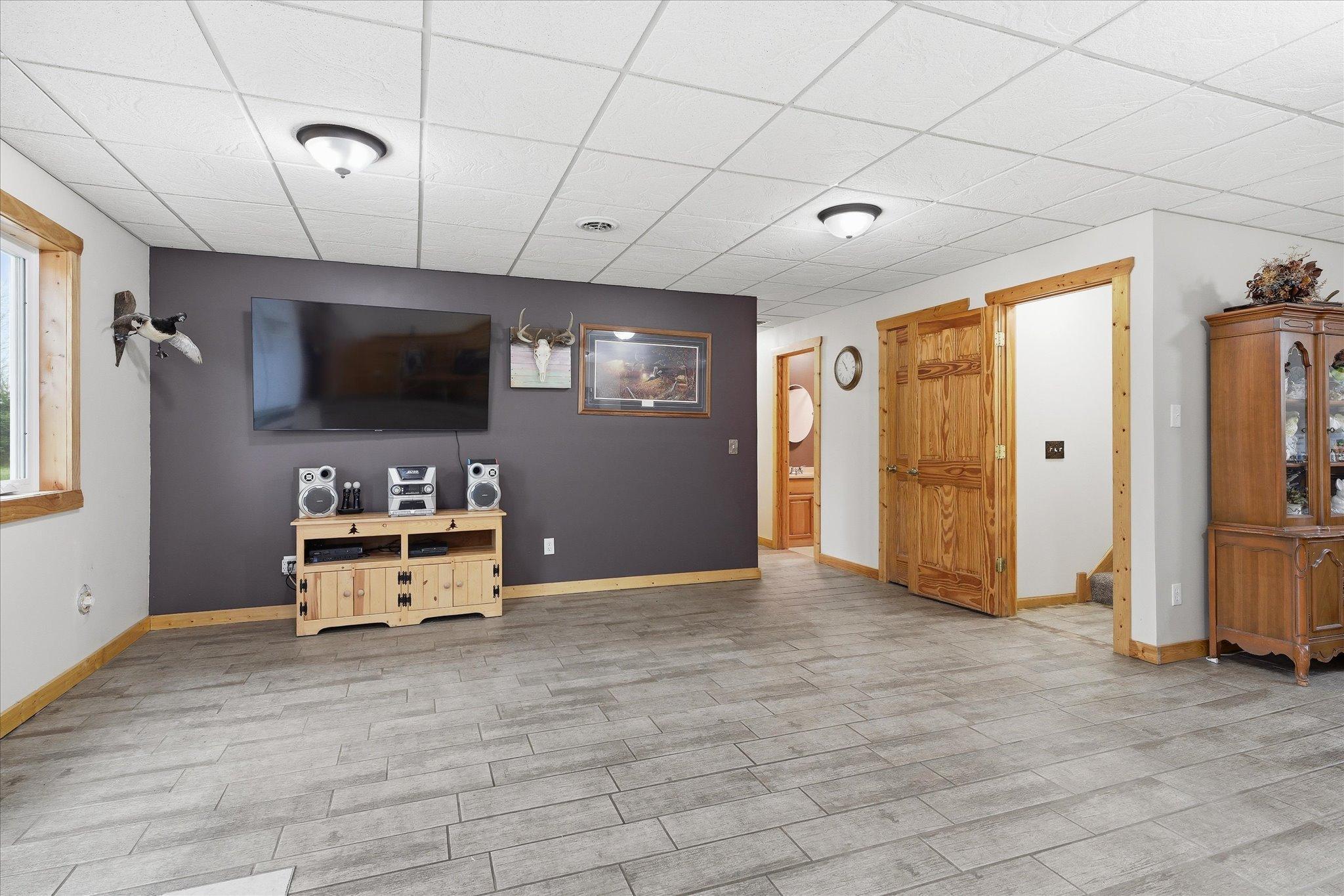 The lower level offers a spacious family room with a pellet stove, walkout access to the backyard, two additional bedrooms, full bathroom, laundry and storage.