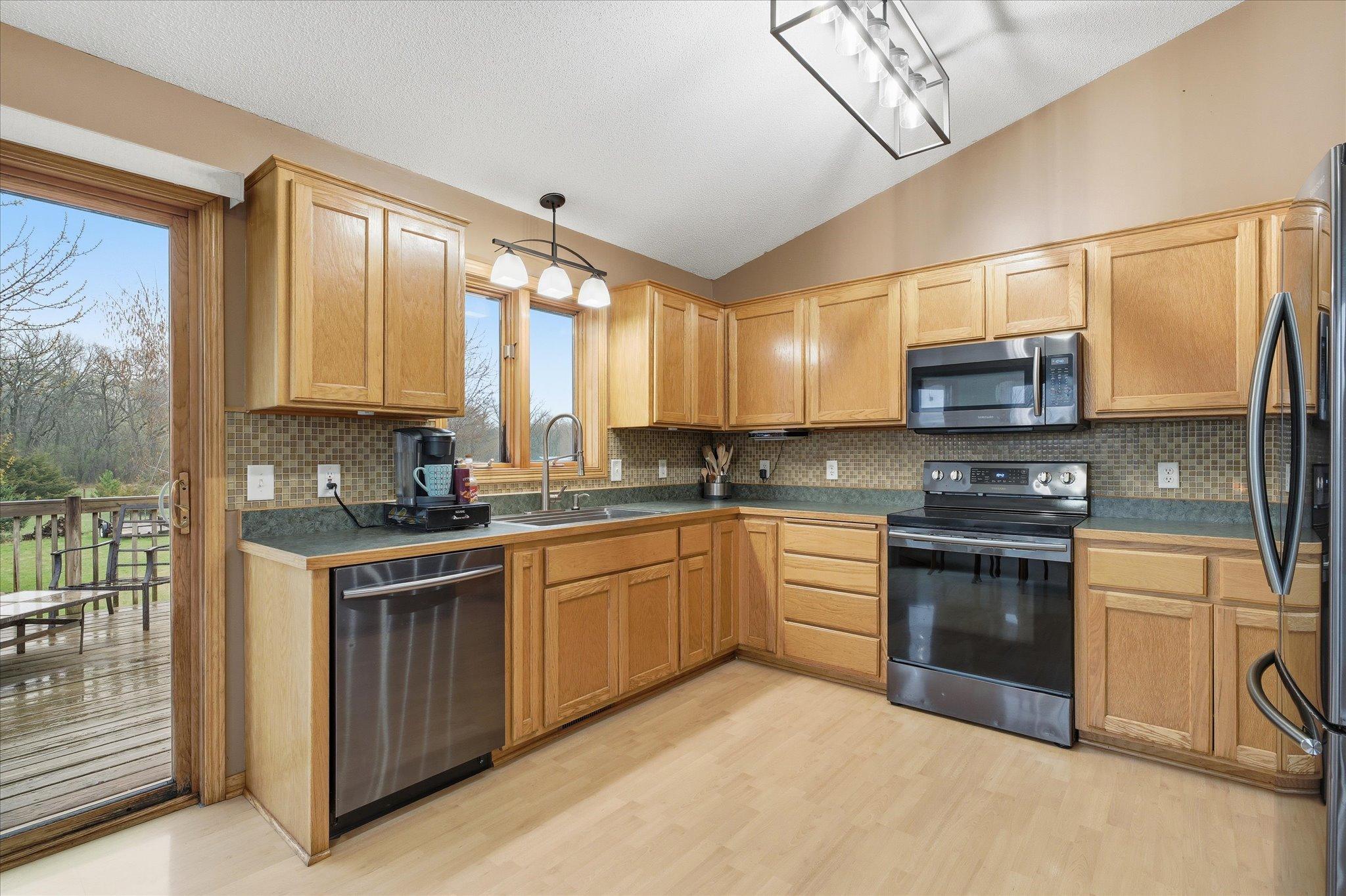 Kitchen with ample cabinet space and updated lighting